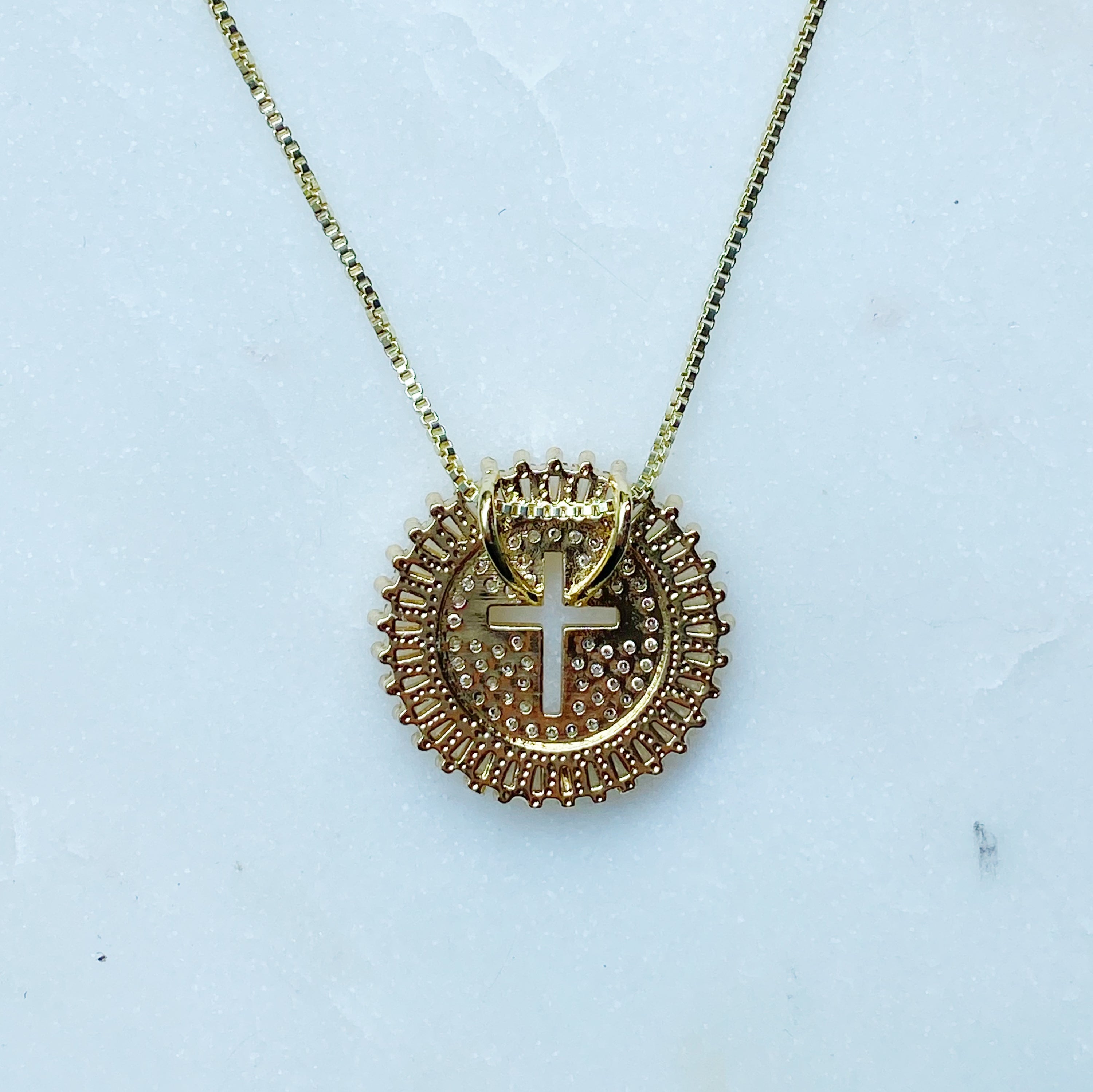 Shine Circle Cross Necklace featuring a sparkly round charm with a cut-out cross design, plated brass, and cubic zirconia.