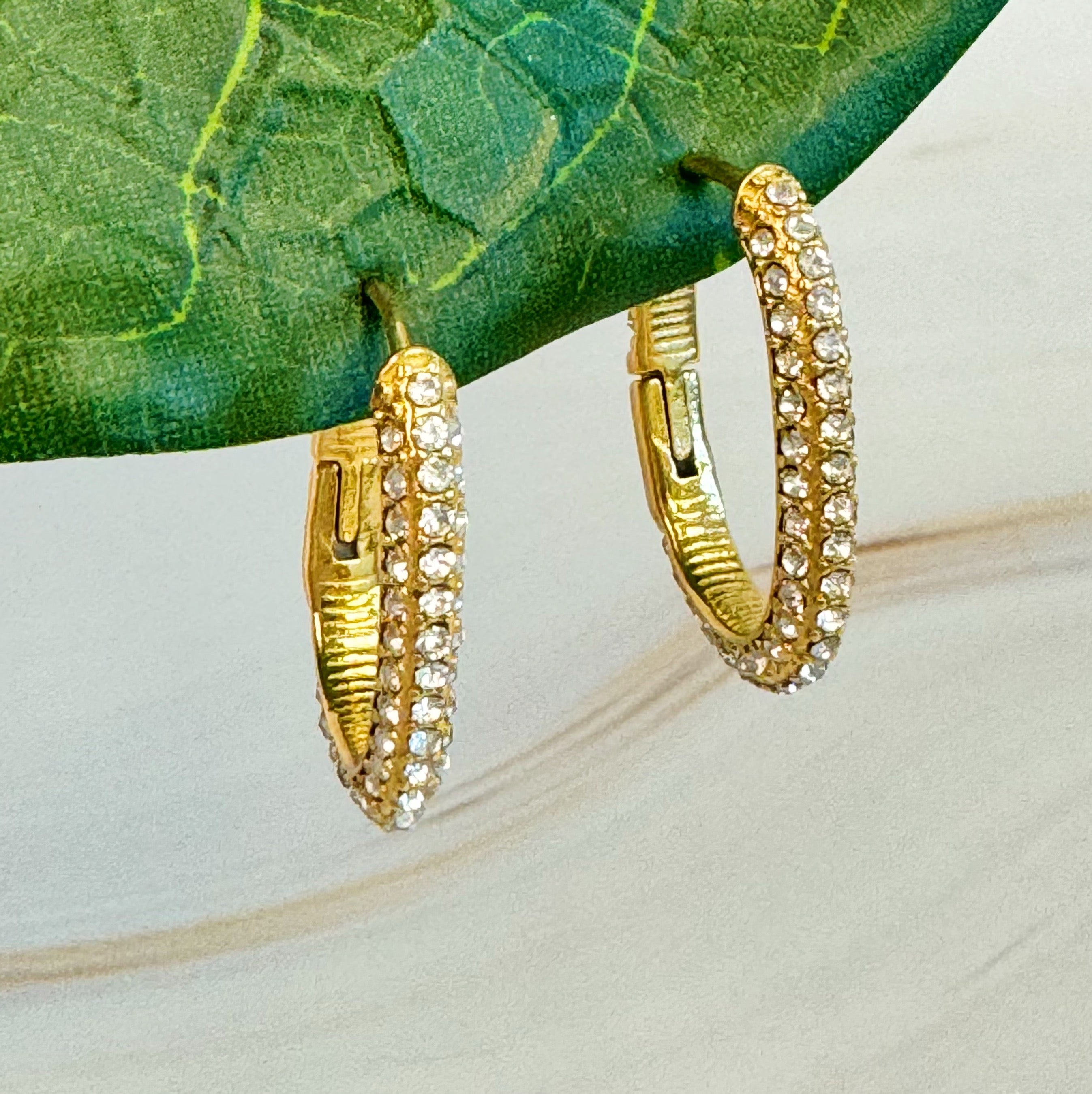 Sophisticated Shine Covered Oval Hoop Earrings in 18k gold plated stainless steel, showcasing their elegant oval shape and shiny finish.