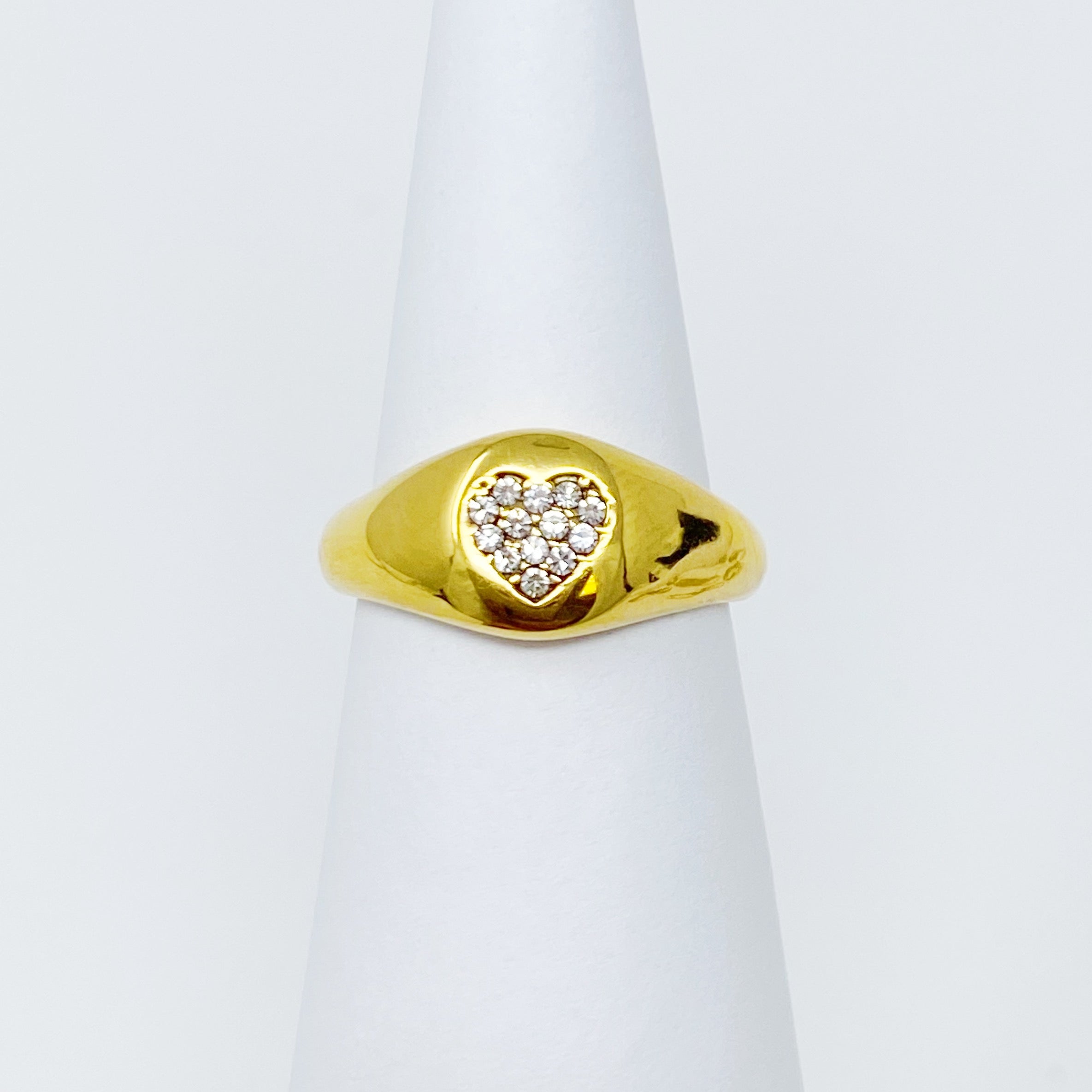 Shine Me Heart Ring featuring a bold golden design with a heart shape adorned with sparkling cubic zirconia stones.