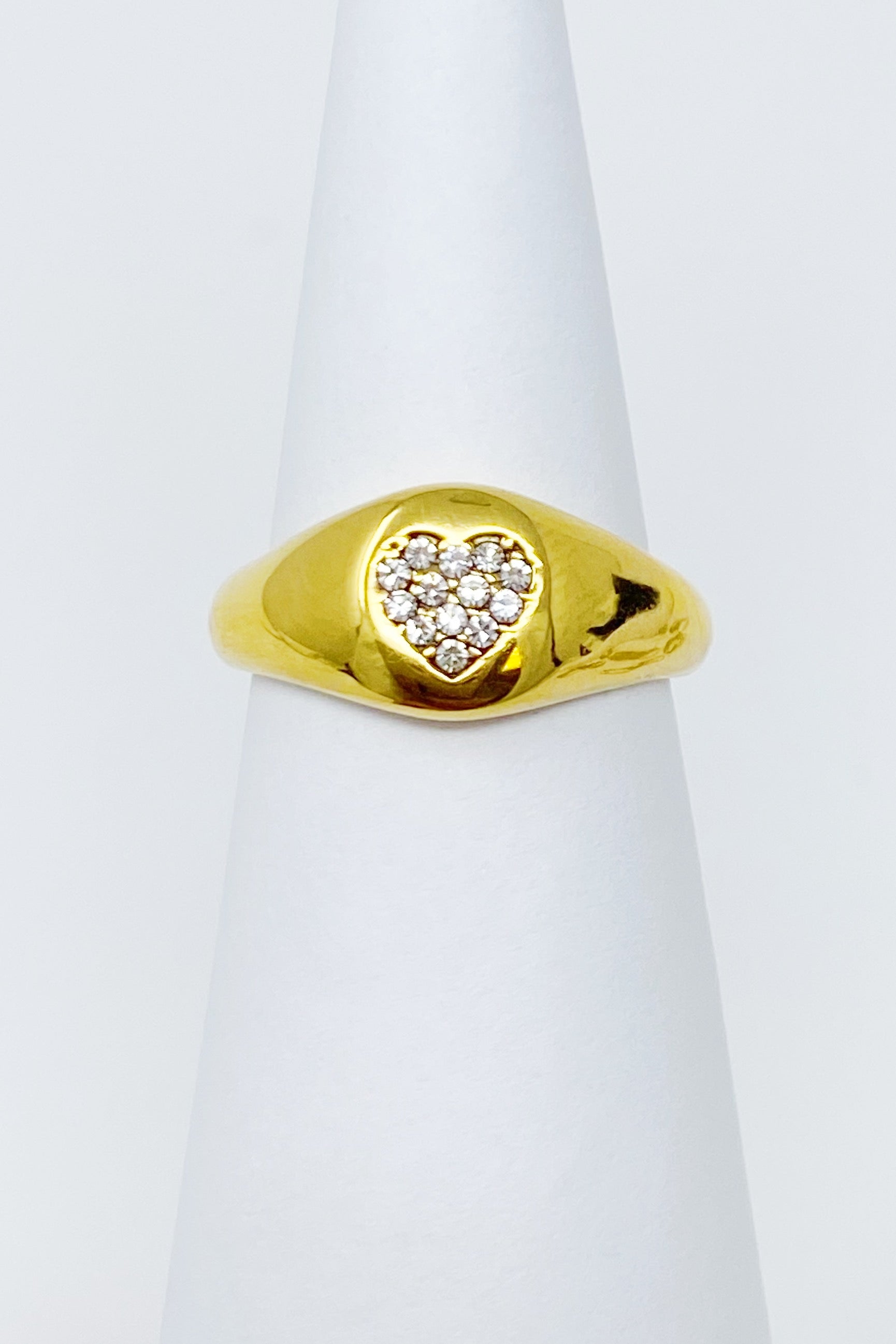 Shine Me Heart Ring featuring a bold golden design with a heart shape adorned with sparkling cubic zirconia stones.