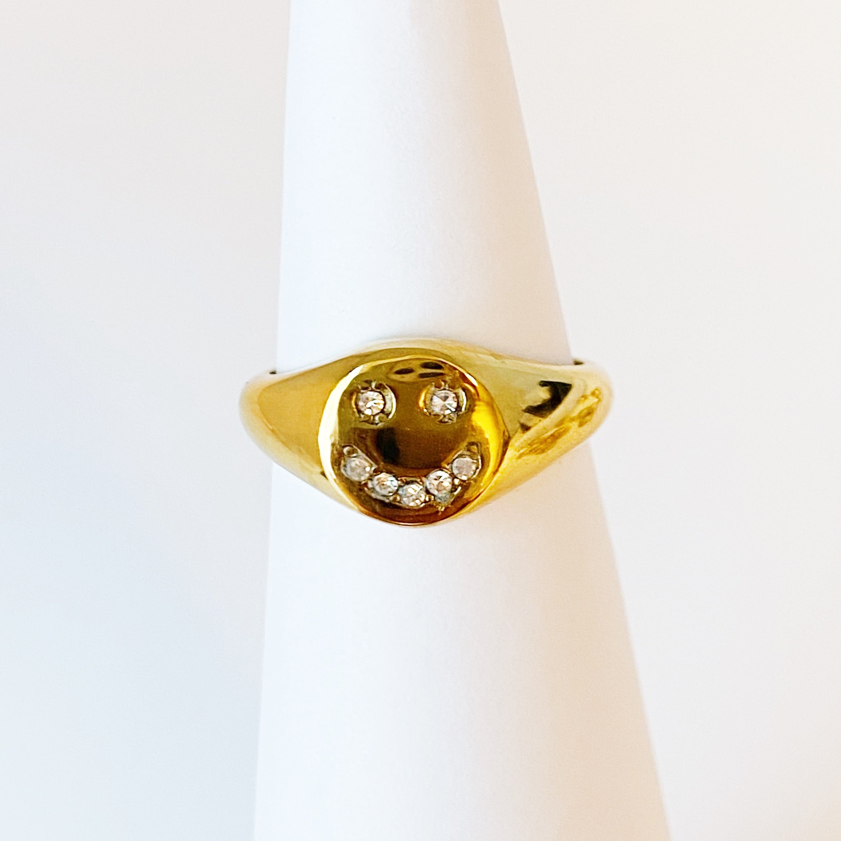 Shine Me Smile Ring featuring a bold golden design with a happy face and shiny Cubic Zirconia stones.