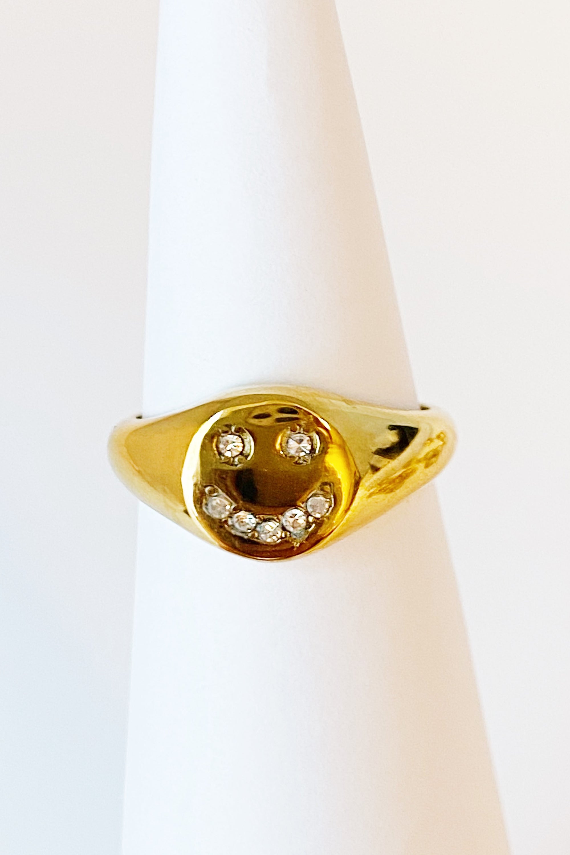 Shine Me Smile Ring featuring a bold golden design with a happy face and shiny Cubic Zirconia stones.