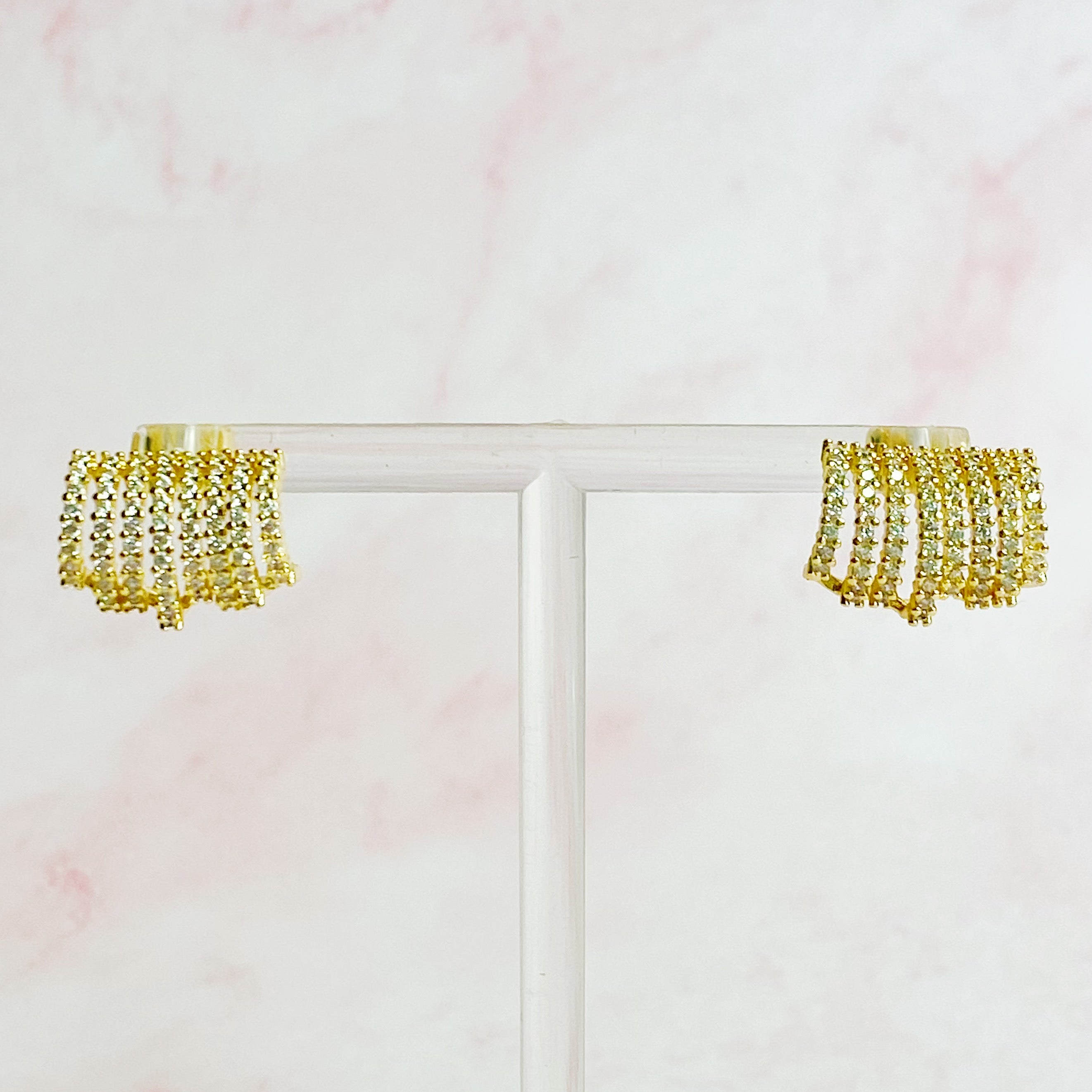 Elegant Shines In A Row Half Hoop Earrings featuring 18K gold or rhodium plating and sparkling cubic zirconia.