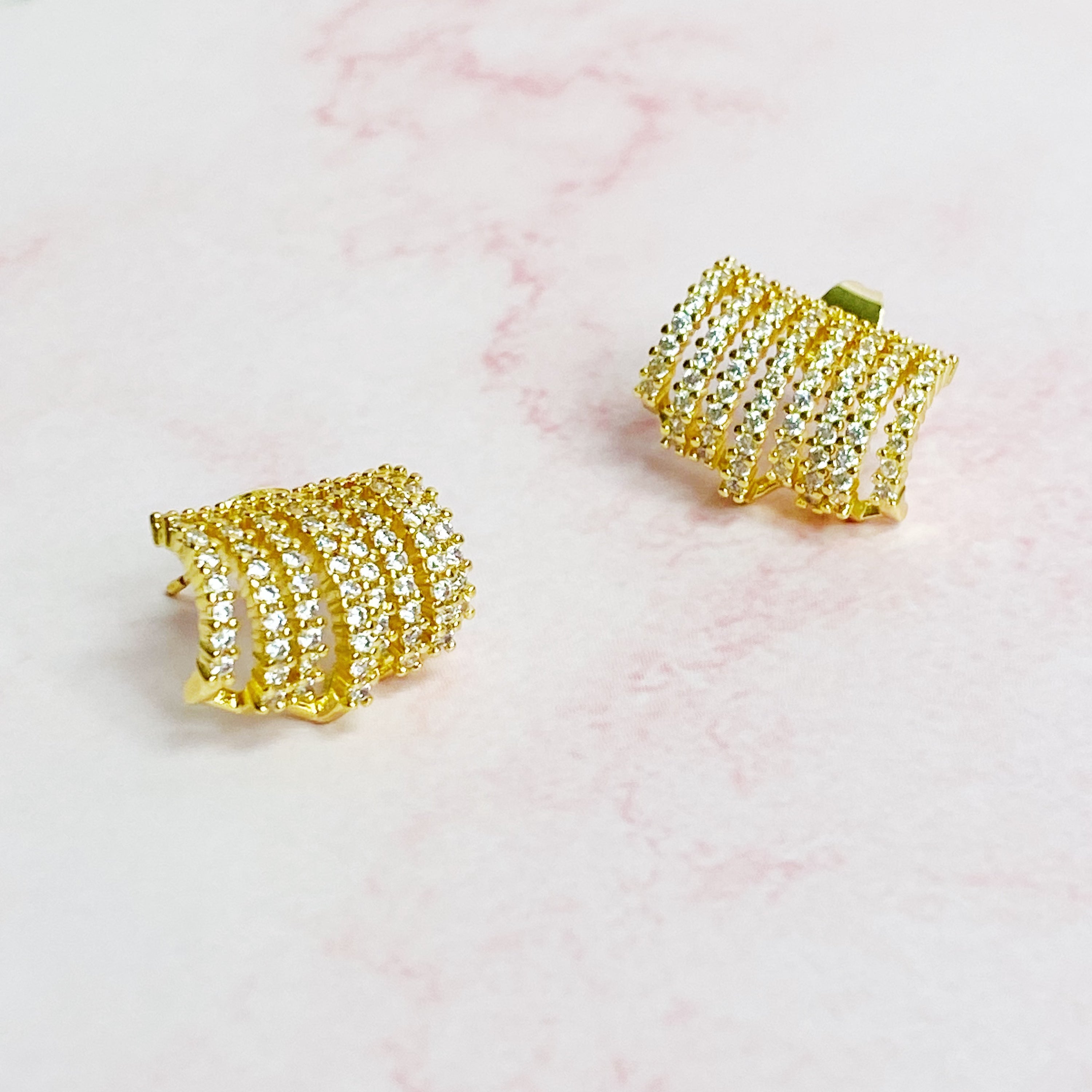 Elegant Shines In A Row Half Hoop Earrings featuring 18K gold or rhodium plating and sparkling cubic zirconia.