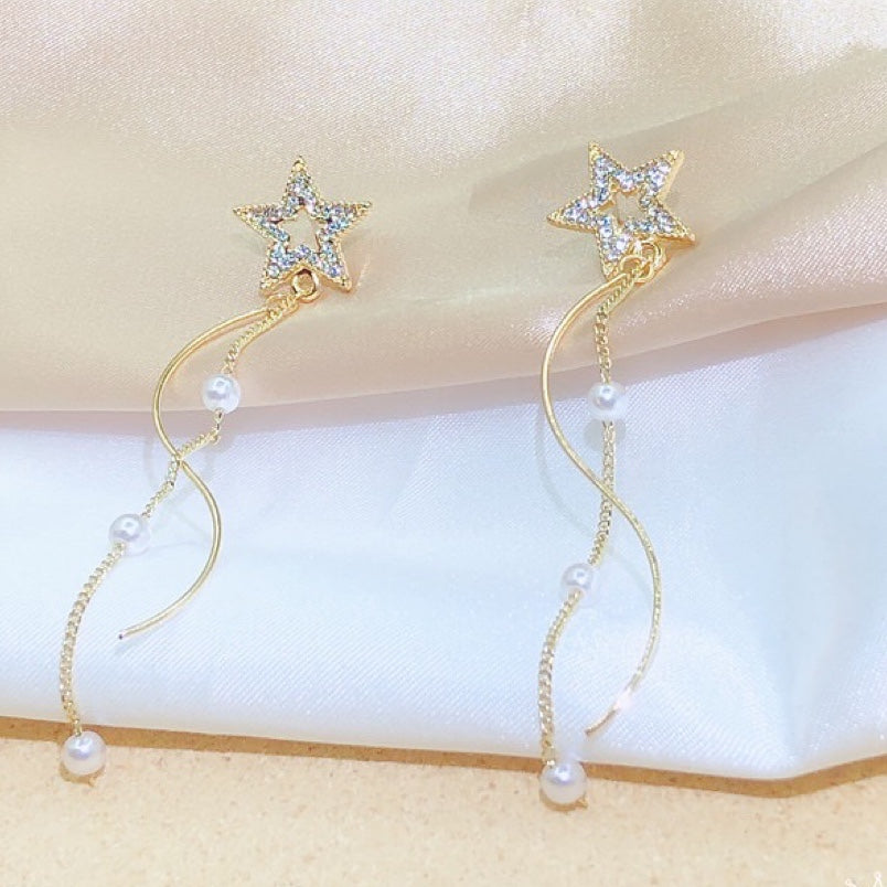 A pair of Shining Star earrings featuring elegant pearl tassels, crafted from durable alloy, showcasing a unique star design.