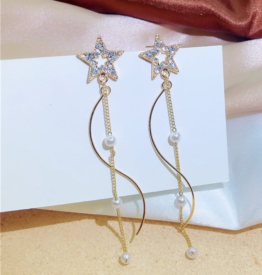 A pair of Shining Star earrings featuring elegant pearl tassels, crafted from durable alloy, showcasing a unique star design.