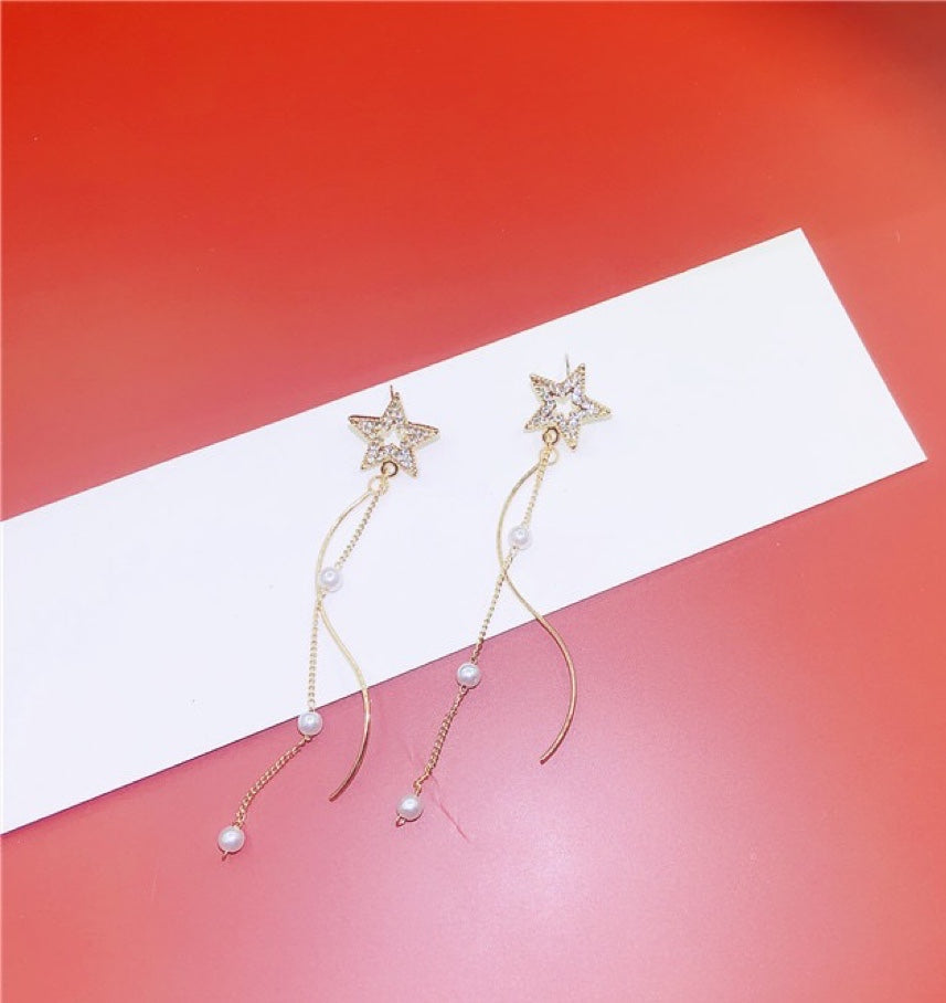 A pair of Shining Star earrings featuring elegant pearl tassels, crafted from durable alloy, showcasing a unique star design.