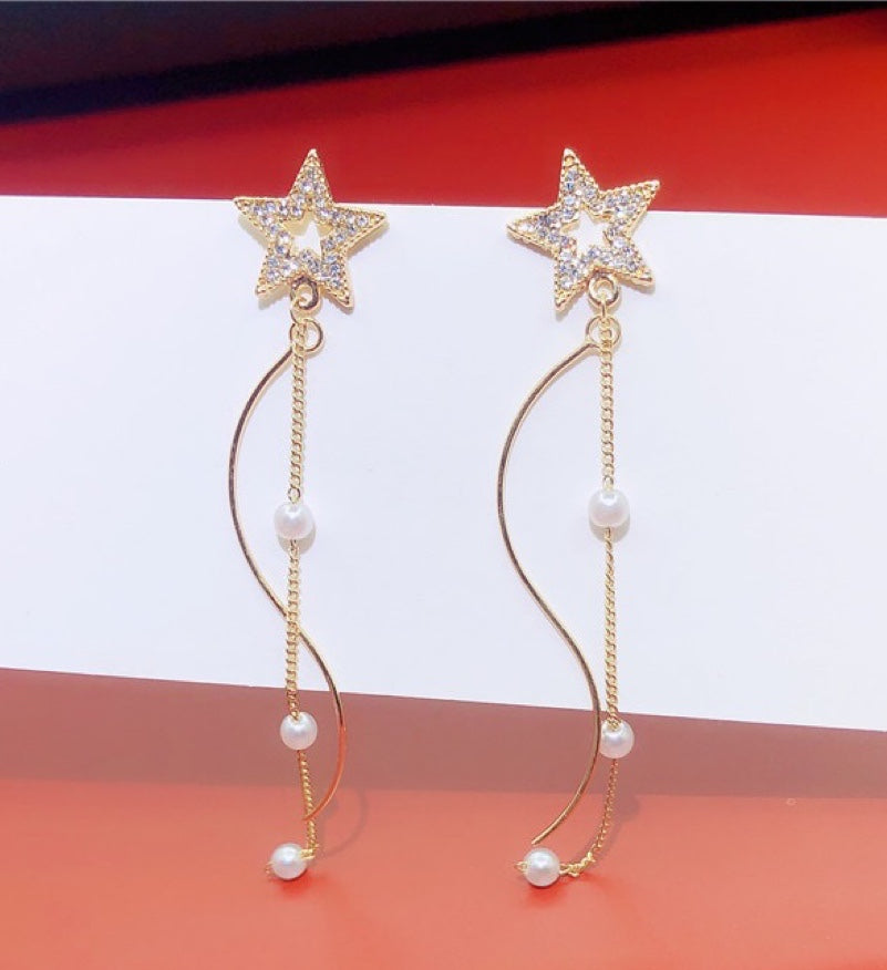 A pair of Shining Star earrings featuring elegant pearl tassels, crafted from durable alloy, showcasing a unique star design.