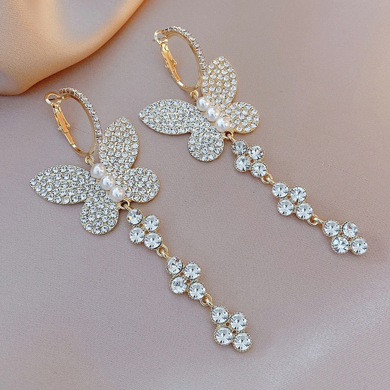 Elegant shiny big butterfly earrings with rhinestone tassels, showcasing intricate design and sparkling details.