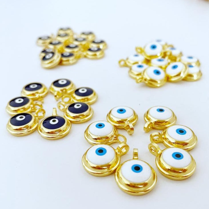 A collection of shiny gold evil eye beads, featuring blue and white designs, perfect for DIY jewelry making.