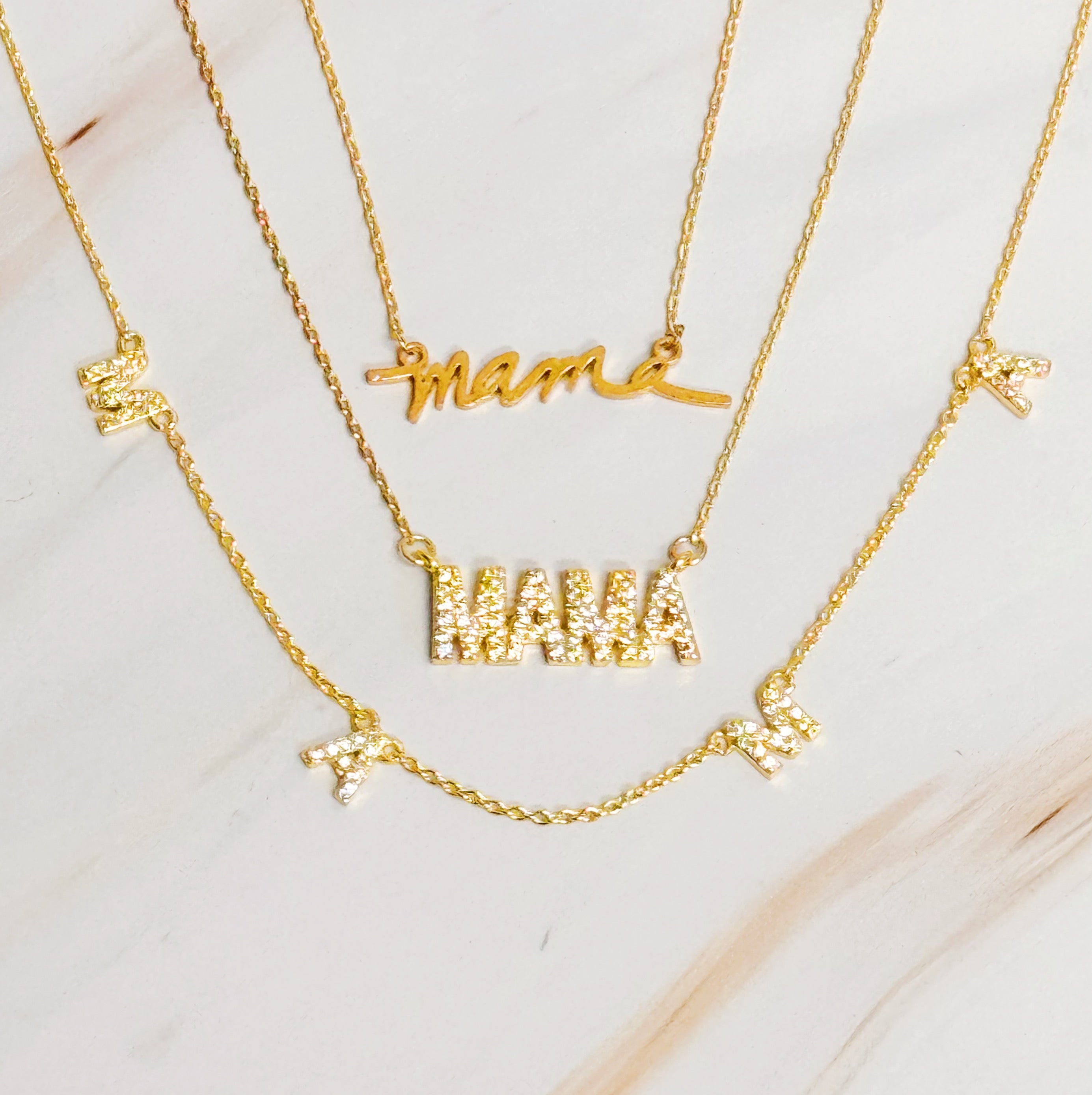 Shiny Mama Necklace featuring a clean font design with sparkling cubic zirconia stones on an 18k gold plated brass chain.