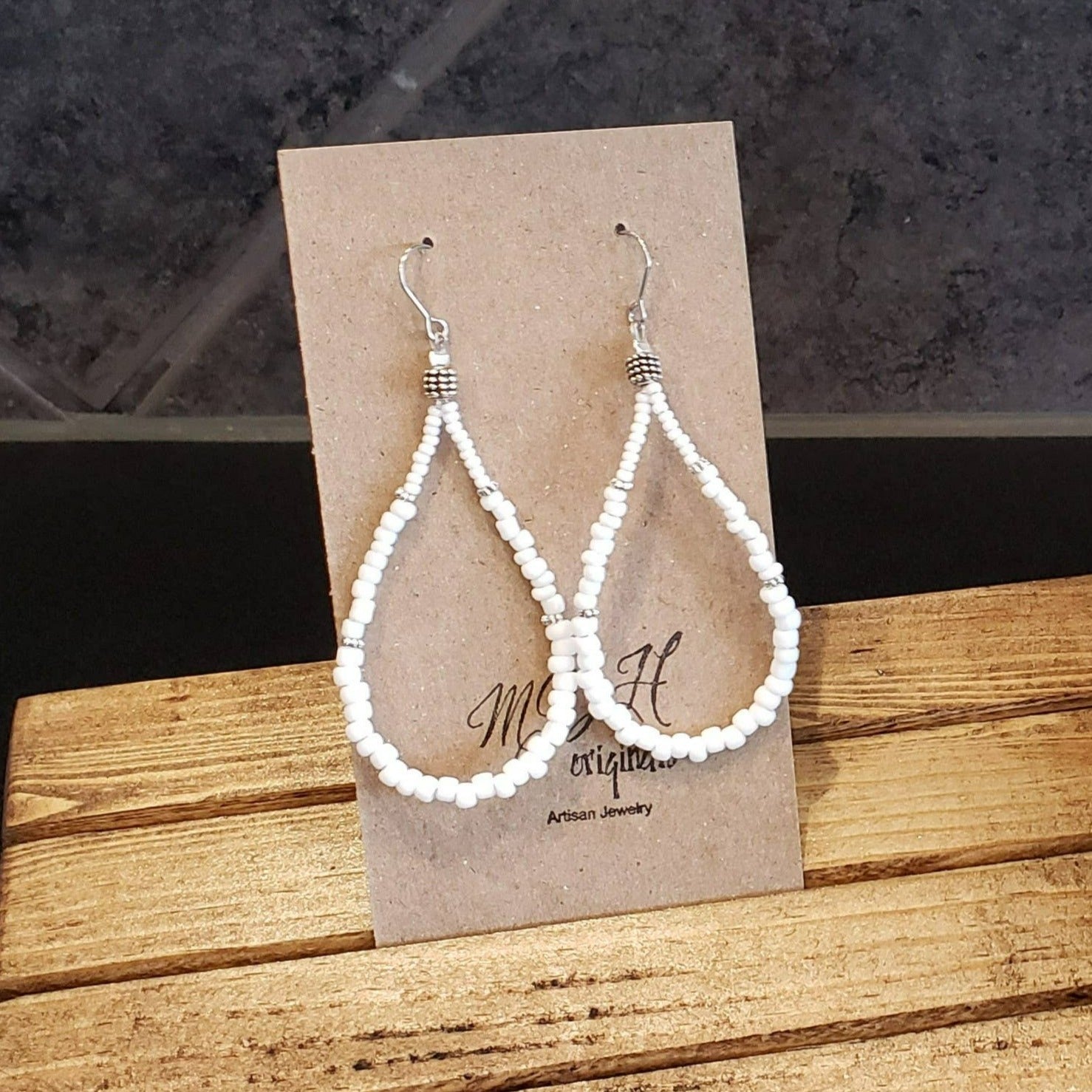 Elegant Shirley White Teardrop Earrings handcrafted with white seed beads, showcasing a lightweight and stylish design.