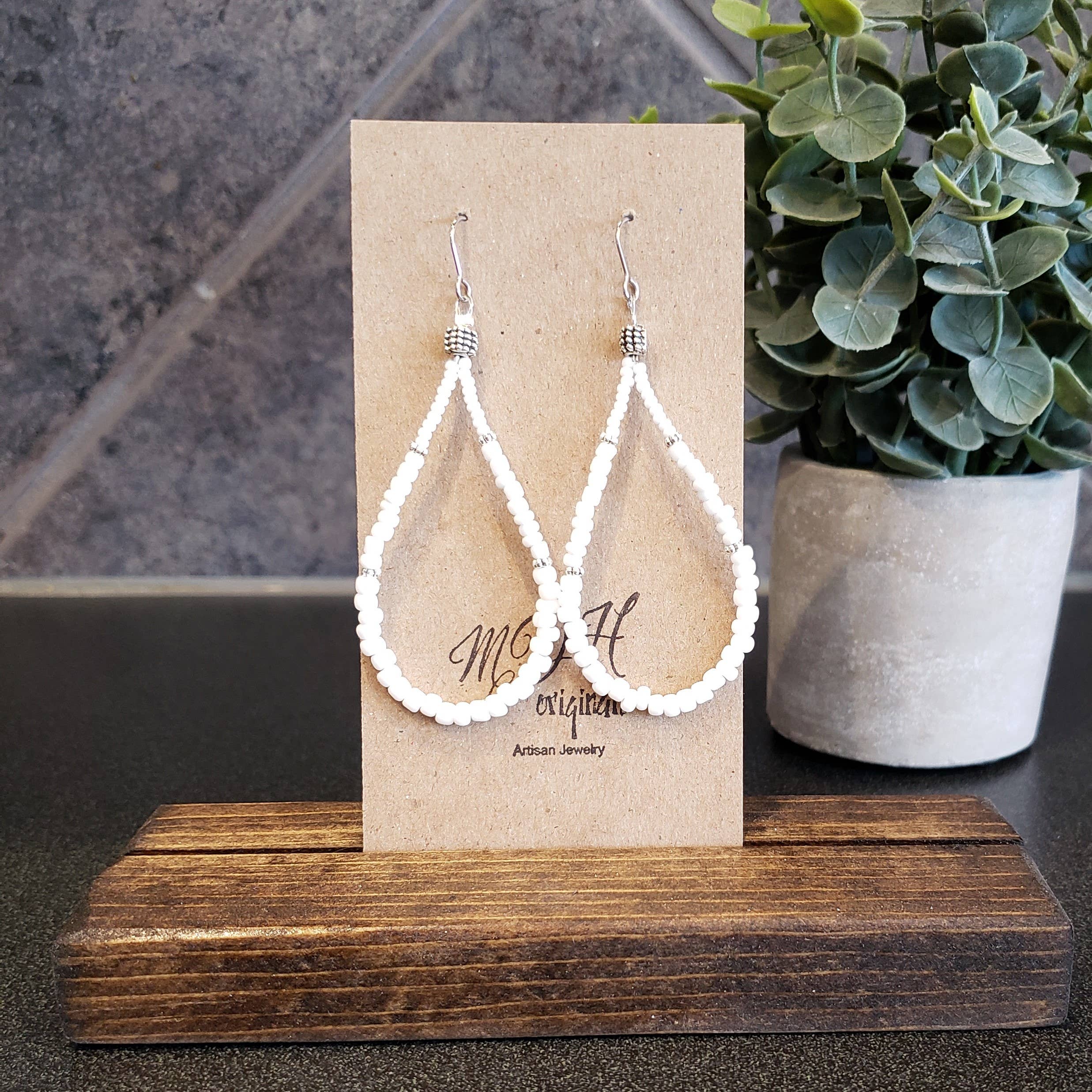 Elegant Shirley White Teardrop Earrings handcrafted with white seed beads, showcasing a lightweight and stylish design.