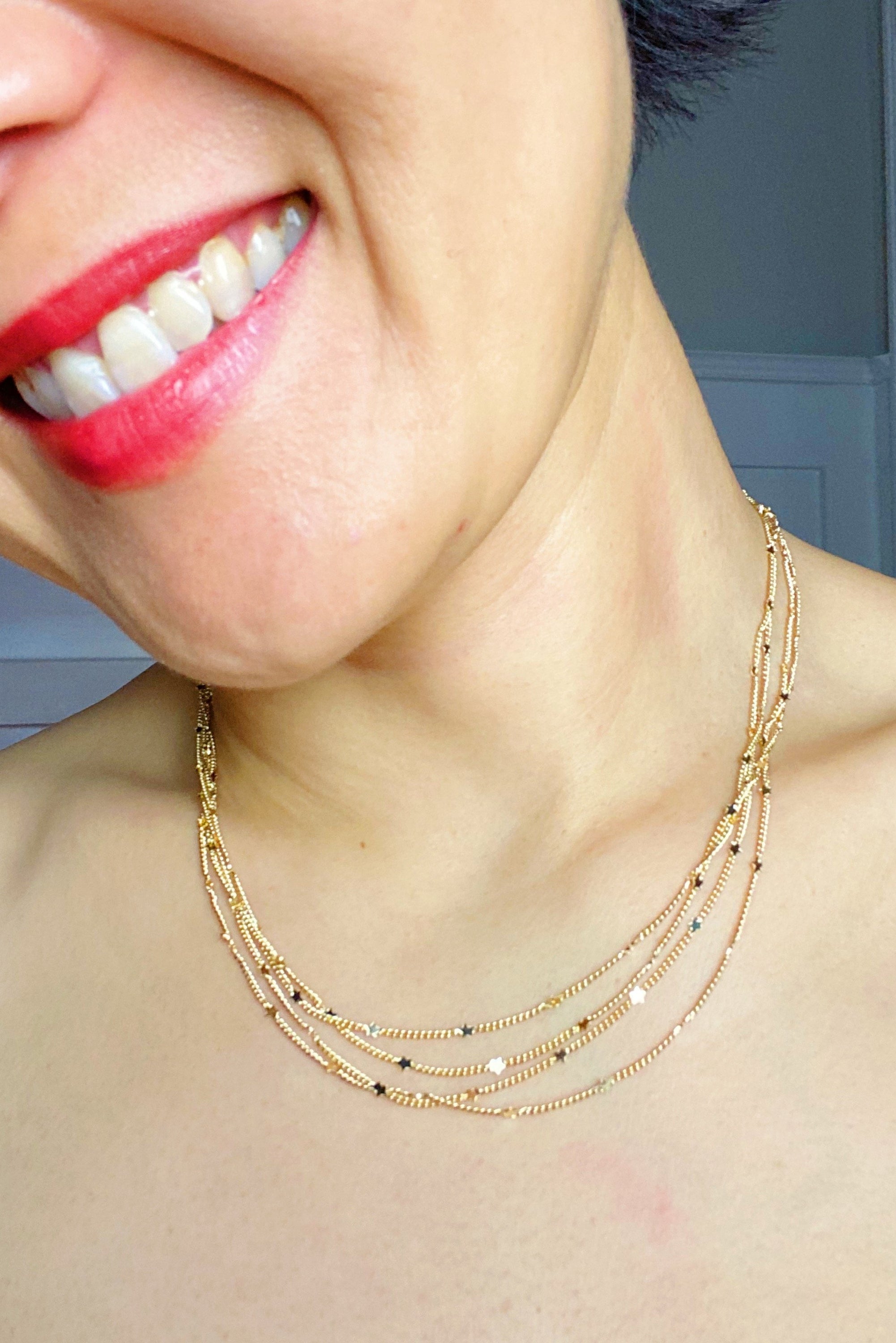 Show Me The Ways Necklace in Gold featuring tiny stars on a long linked chain, showcasing its elegant design and versatility.