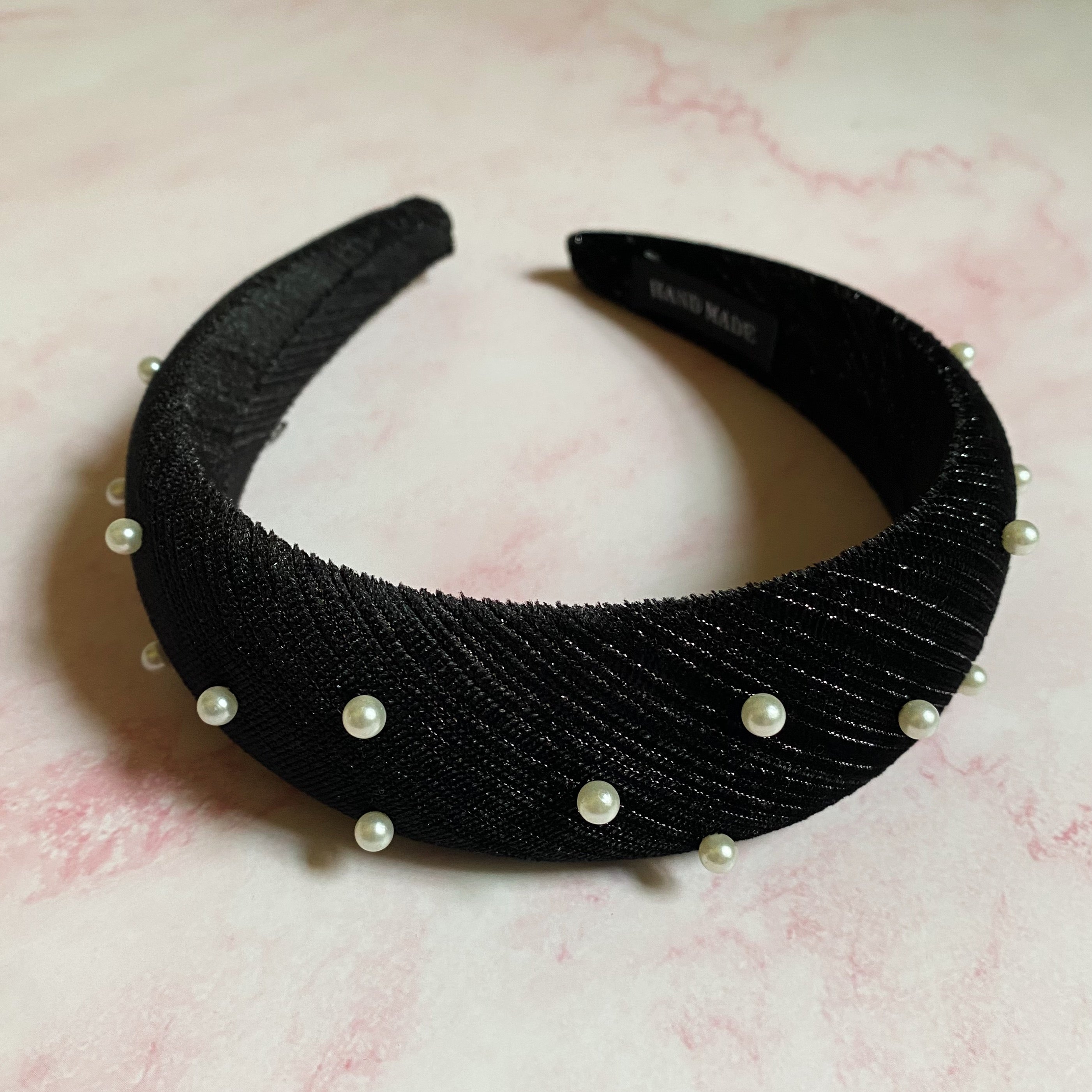 A luxurious handmade Silky Velvet Pearl Headband featuring textured velvet and delicate pearls, perfect for special occasions.