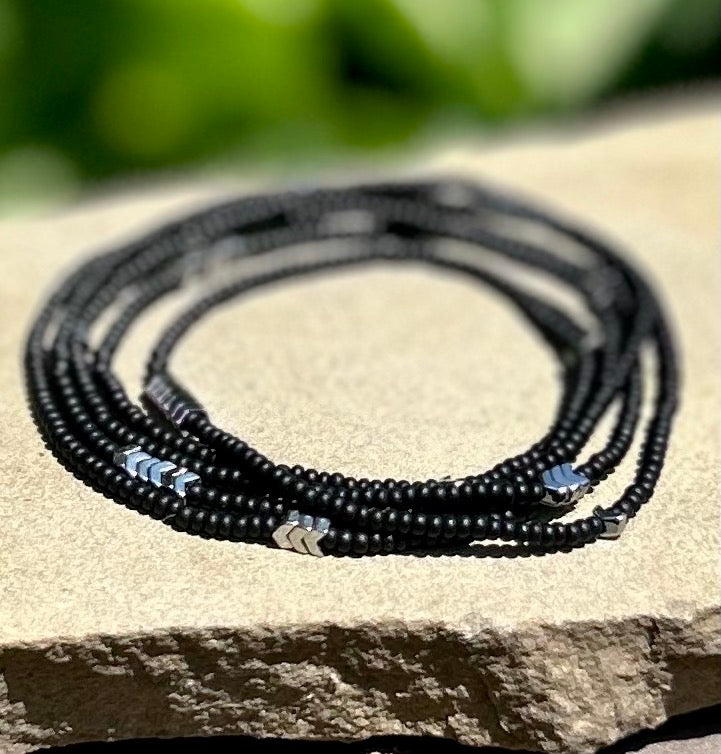 Silver Arrow & Black 5-Wrap Boho Beaded Bracelet featuring Czech glass beads and silver hematite arrows, elegantly wrapped around a wrist.