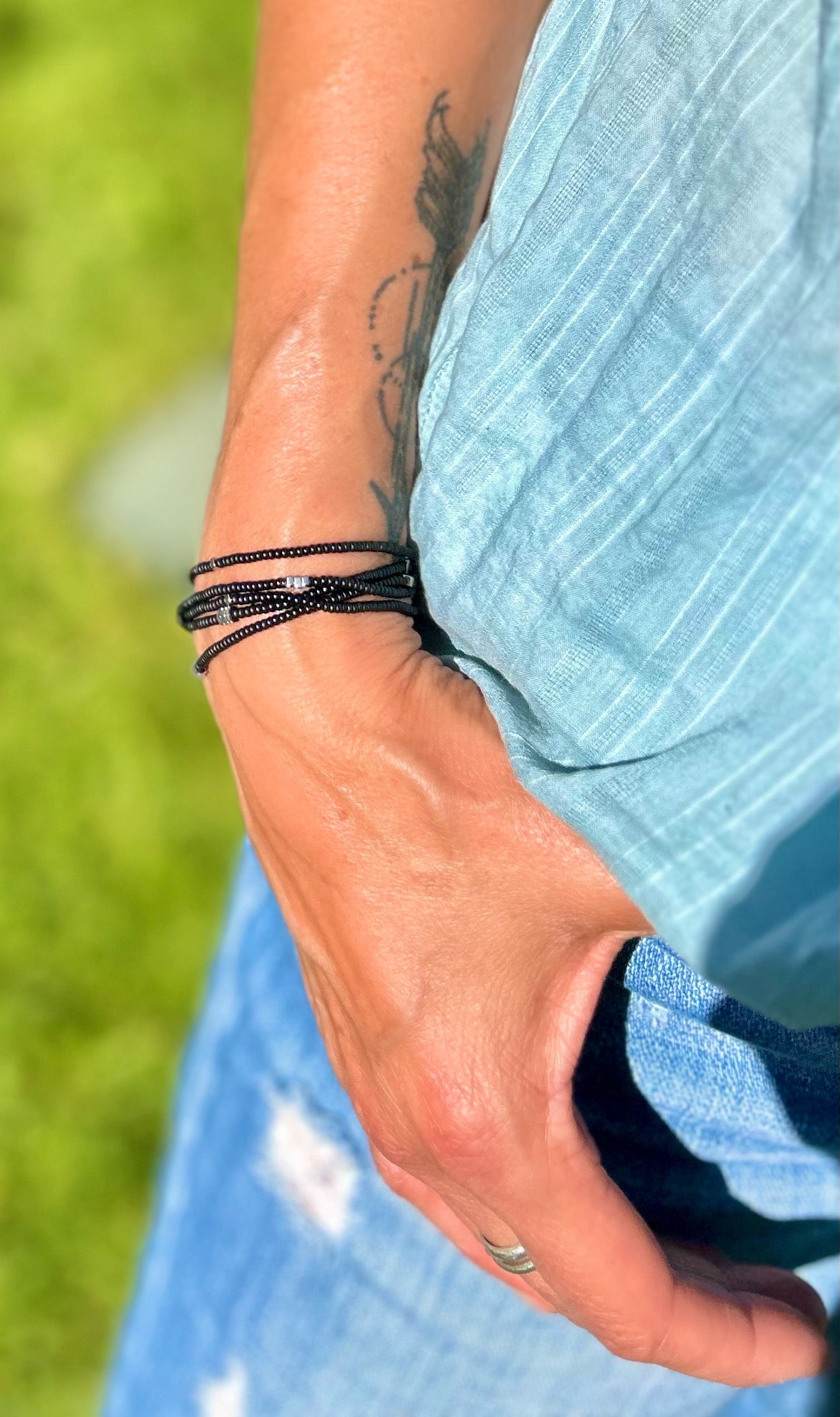 Silver Arrow & Black 5-Wrap Boho Beaded Bracelet featuring Czech glass beads and silver hematite arrows, elegantly wrapped around a wrist.