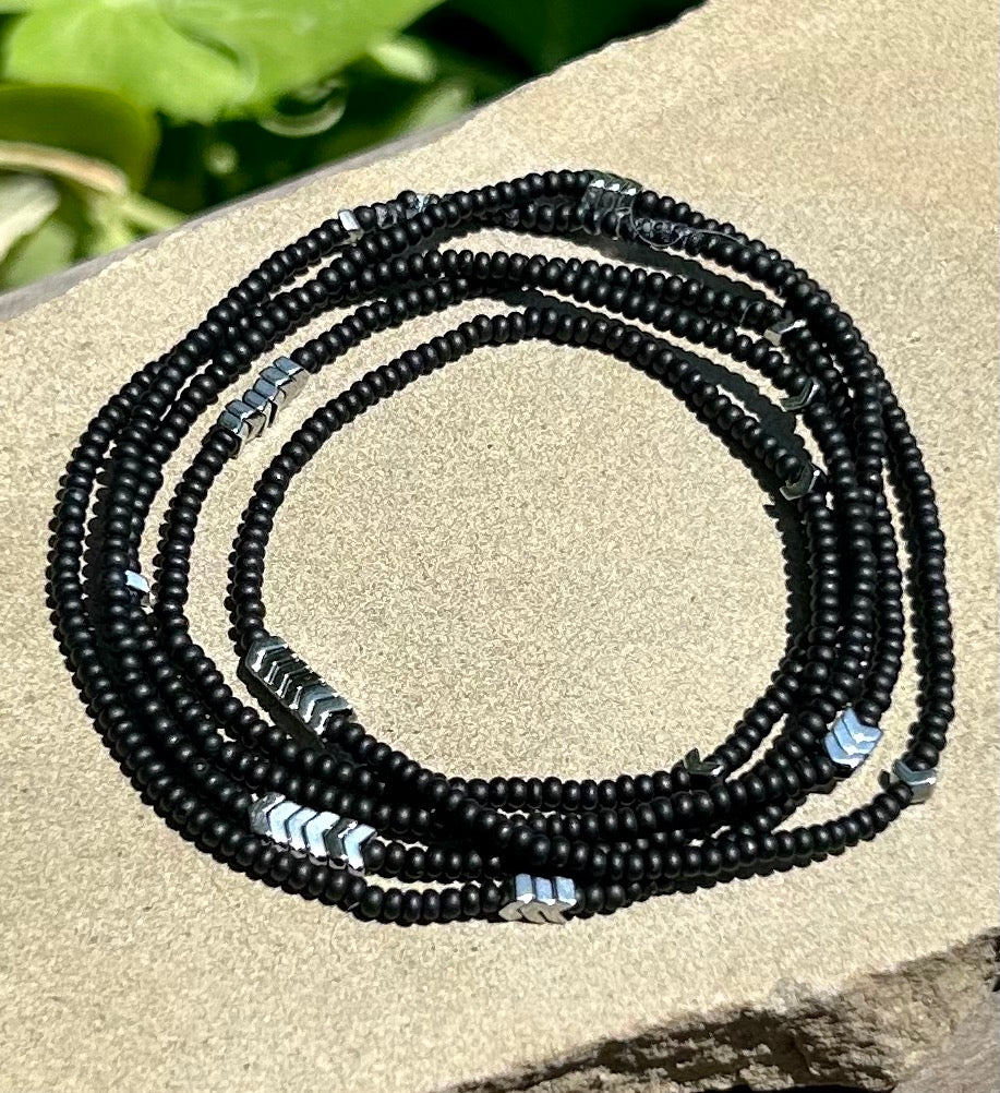 Silver Arrow & Black 5-Wrap Boho Beaded Bracelet featuring Czech glass beads and silver hematite arrows, elegantly wrapped around a wrist.