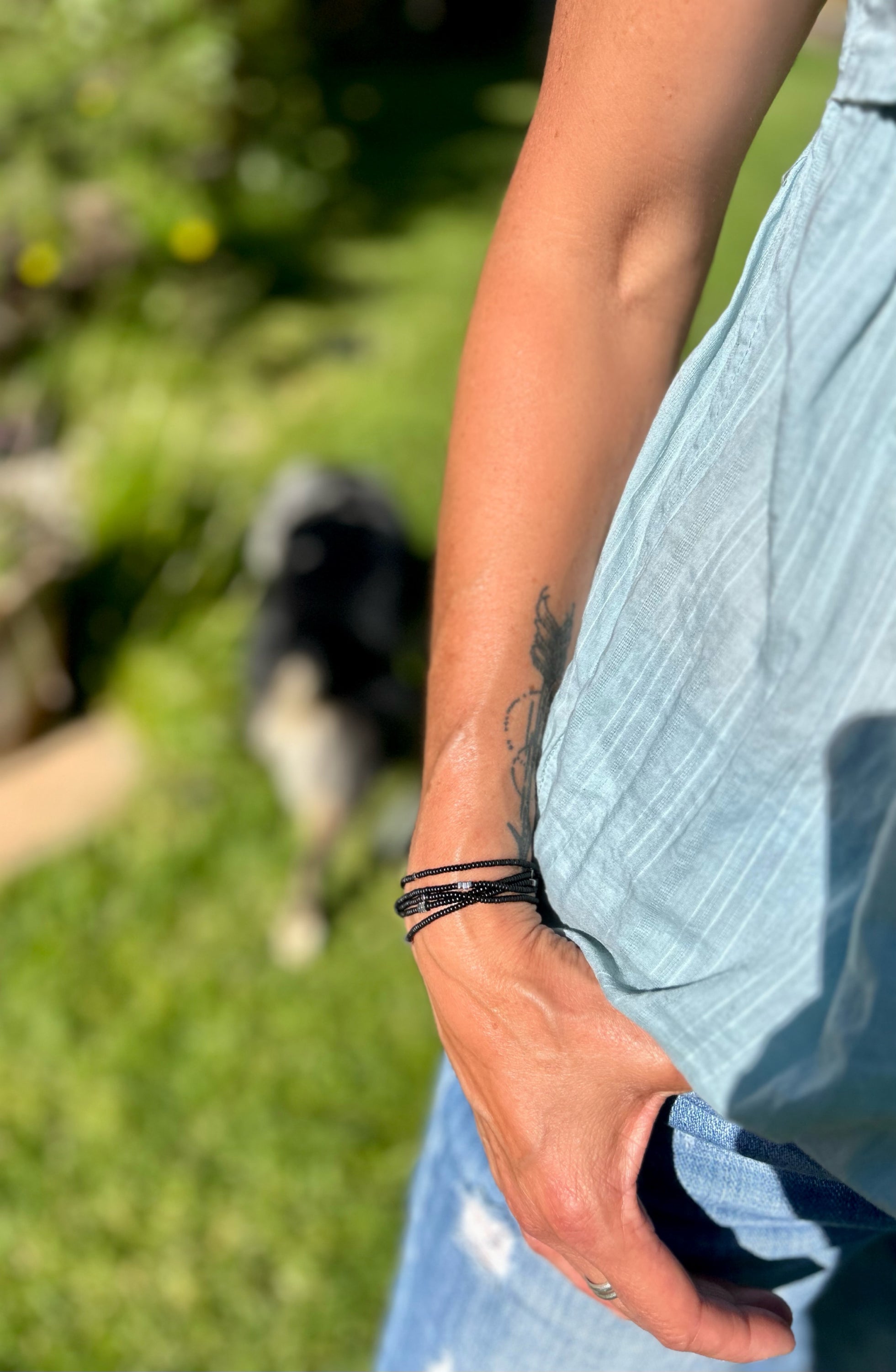 Silver Arrow & Black 5-Wrap Boho Beaded Bracelet featuring Czech glass beads and silver hematite arrows, elegantly wrapped around a wrist.