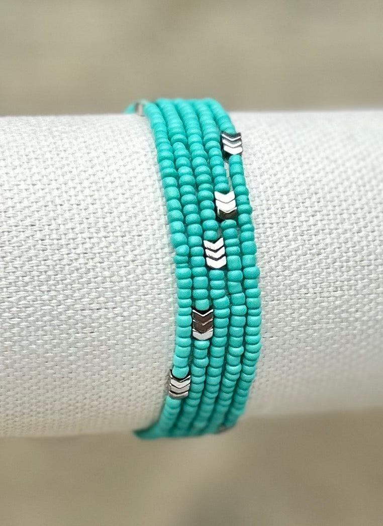 Silver Arrow & Turquoise 5-Wrap Boho Beaded Bracelet featuring matte turquoise beads and silver hematite accents, elegantly wrapped around a wrist.