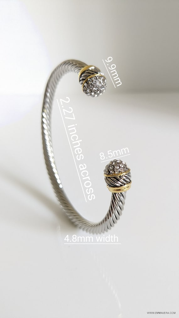 Elegant silver bangle bracelet adorned with simulated diamond accents, showcasing a textured finish and substantial design.