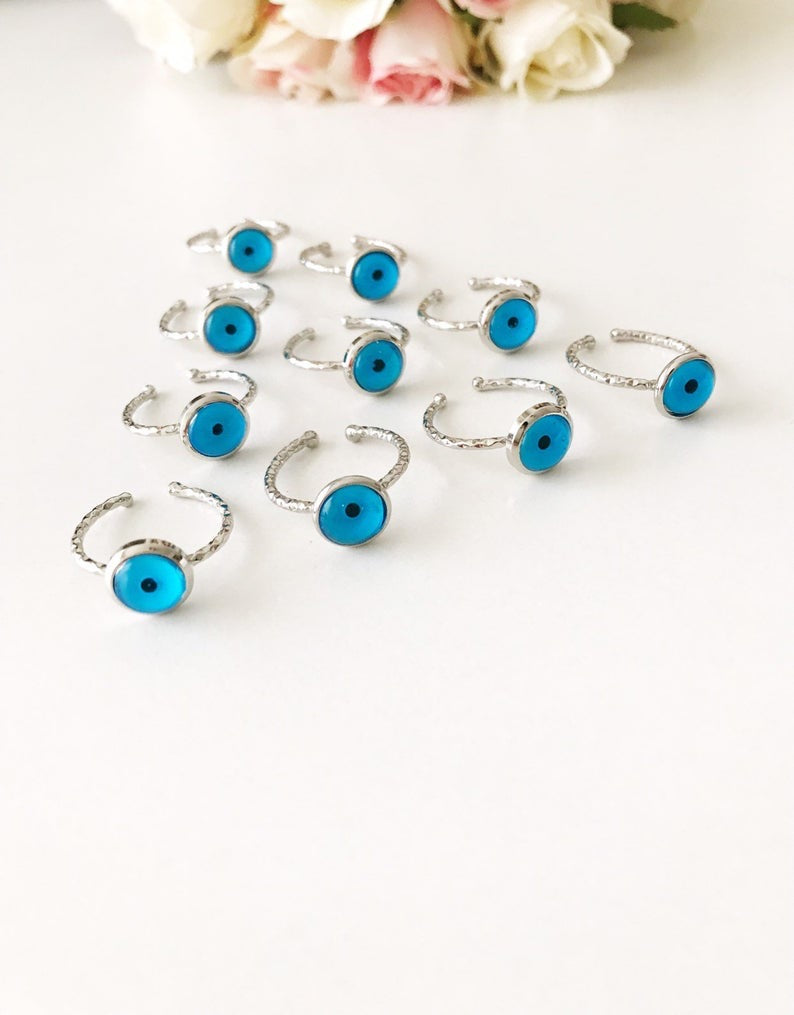 A stylish Silver Blue Evil Eye Ring featuring a blue evil eye bead on a delicate silver band, adjustable for all sizes.