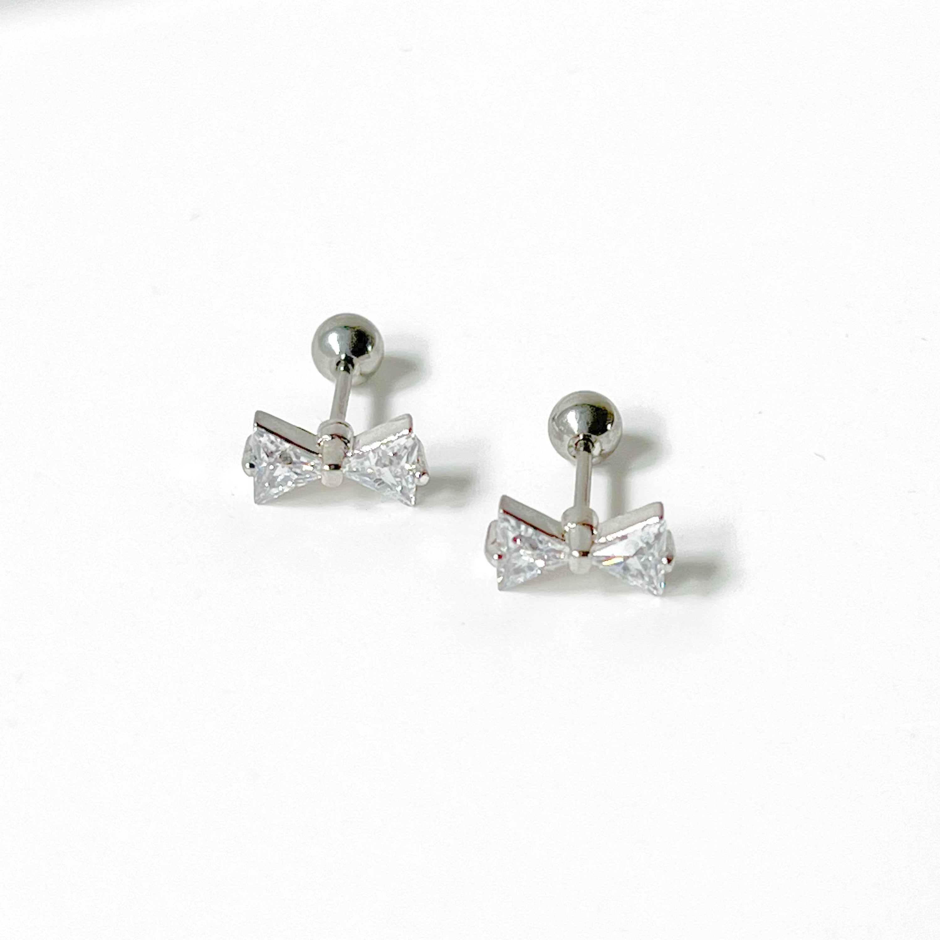 A pair of small silver bow zircon earrings with clear crystals, elegantly designed and hypoallergenic, perfect for gifting.