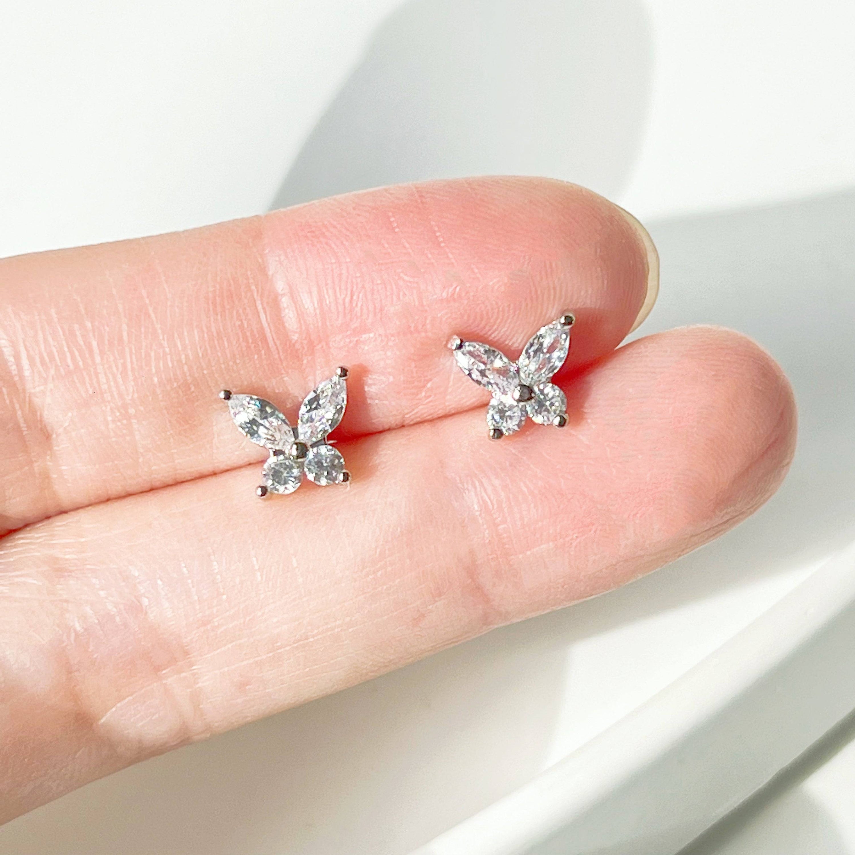 A pair of elegant silver butterfly earrings adorned with clear zircon, showcasing a delicate design.