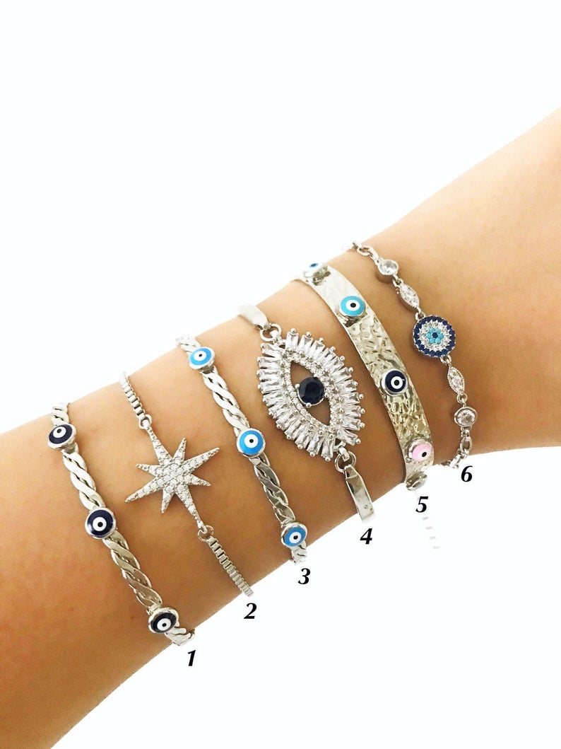 A beautiful Silver Evil Eye Bracelet Set featuring elegant designs, made from tarnish-resistant 316L stainless steel, showcasing the evil eye symbol.