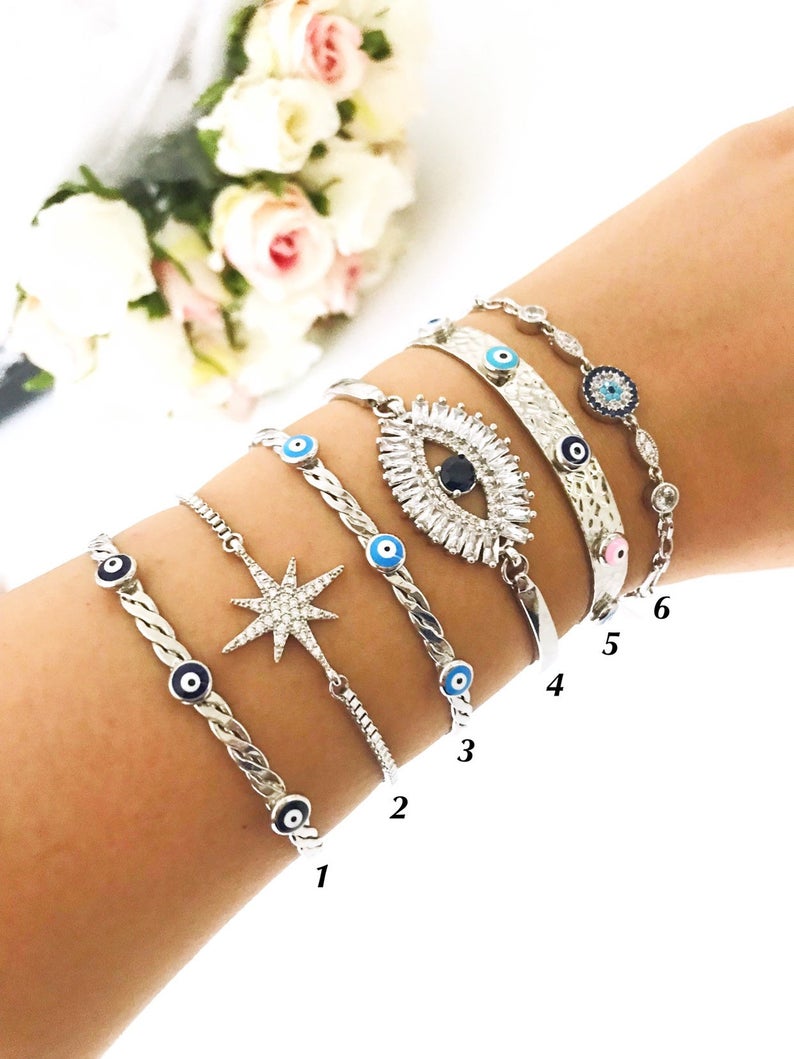 A beautiful Silver Evil Eye Bracelet Set featuring elegant designs, made from tarnish-resistant 316L stainless steel, showcasing the evil eye symbol.