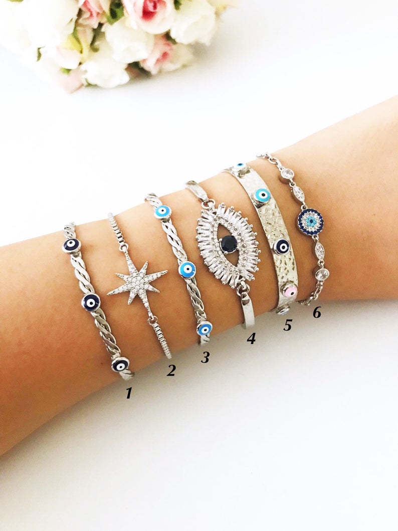 A beautiful Silver Evil Eye Bracelet Set featuring elegant designs, made from tarnish-resistant 316L stainless steel, showcasing the evil eye symbol.