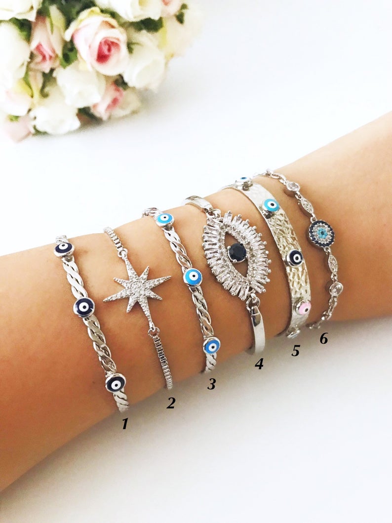 A beautiful Silver Evil Eye Bracelet Set featuring elegant designs, made from tarnish-resistant 316L stainless steel, showcasing the evil eye symbol.