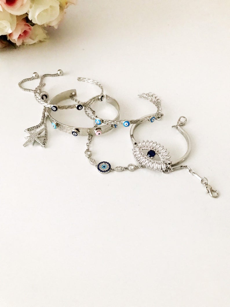 A beautiful Silver Evil Eye Bracelet Set featuring elegant designs, made from tarnish-resistant 316L stainless steel, showcasing the evil eye symbol.