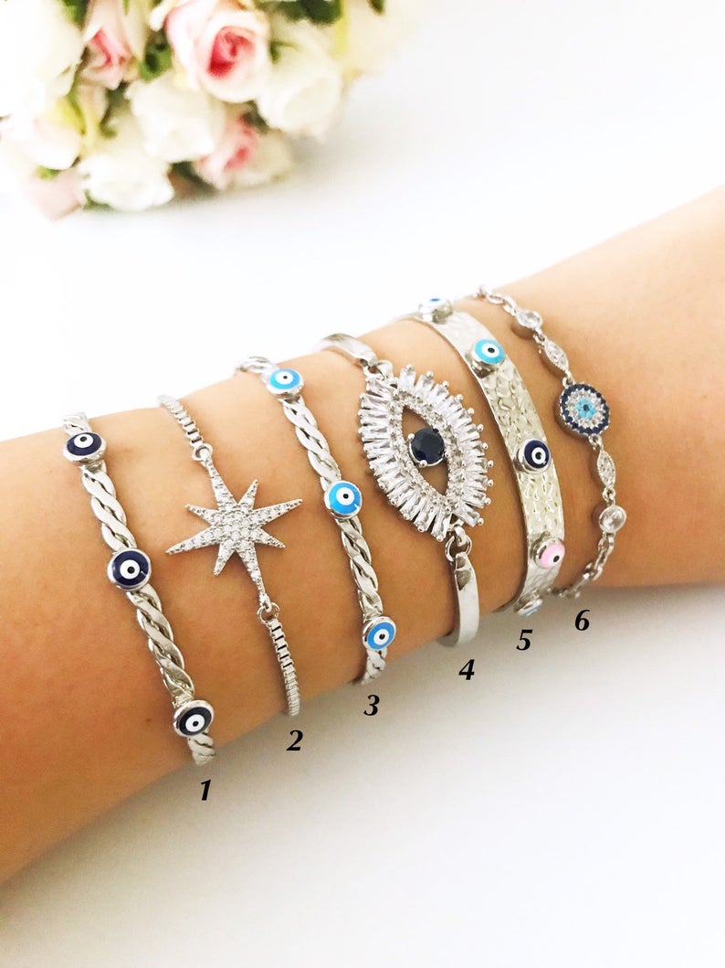 A beautiful Silver Evil Eye Bracelet Set featuring elegant designs, made from tarnish-resistant 316L stainless steel, showcasing the evil eye symbol.