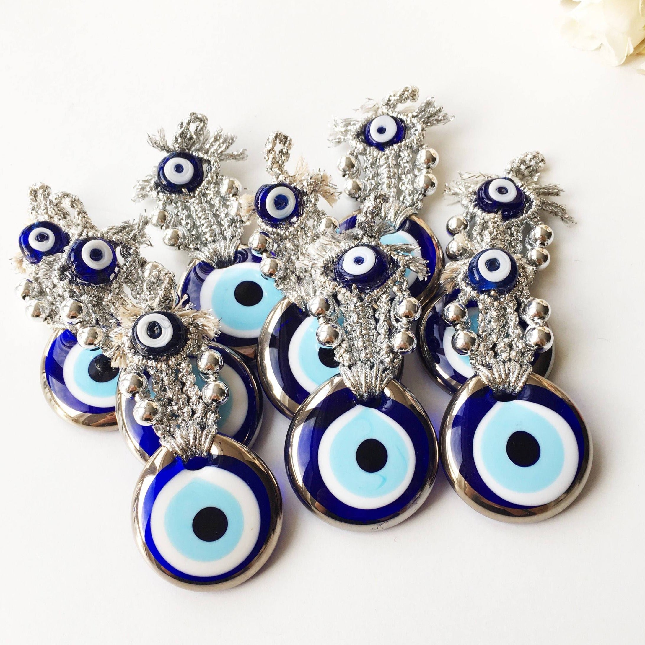 A handmade Silver Evil Eye Macrame Wall Hanging featuring a 4.5cm evil eye bead, crafted with silver macrame rope and gold accents.