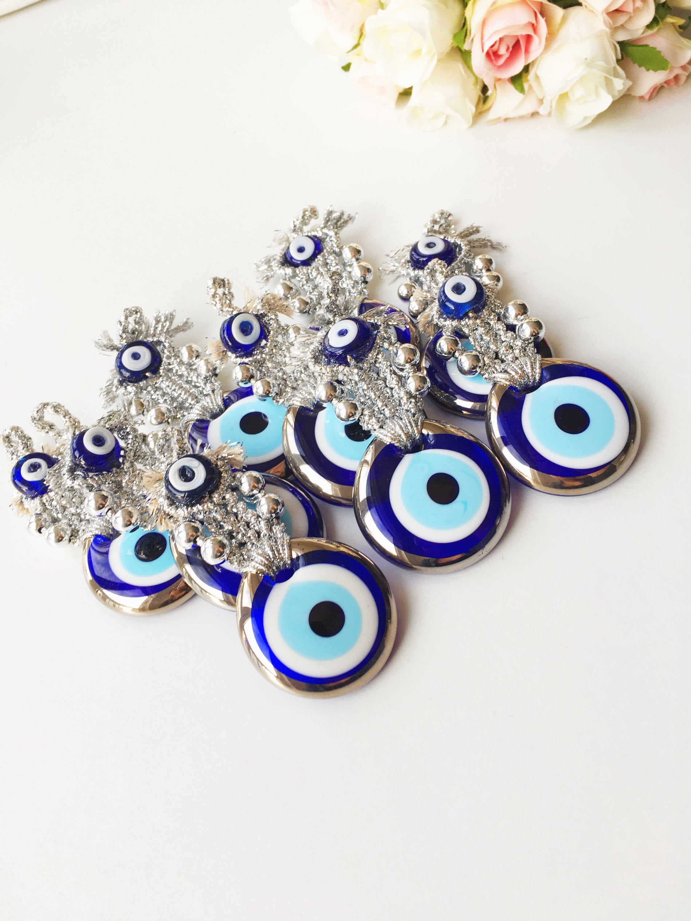 A handmade Silver Evil Eye Macrame Wall Hanging featuring a 4.5cm evil eye bead, crafted with silver macrame rope and gold accents.