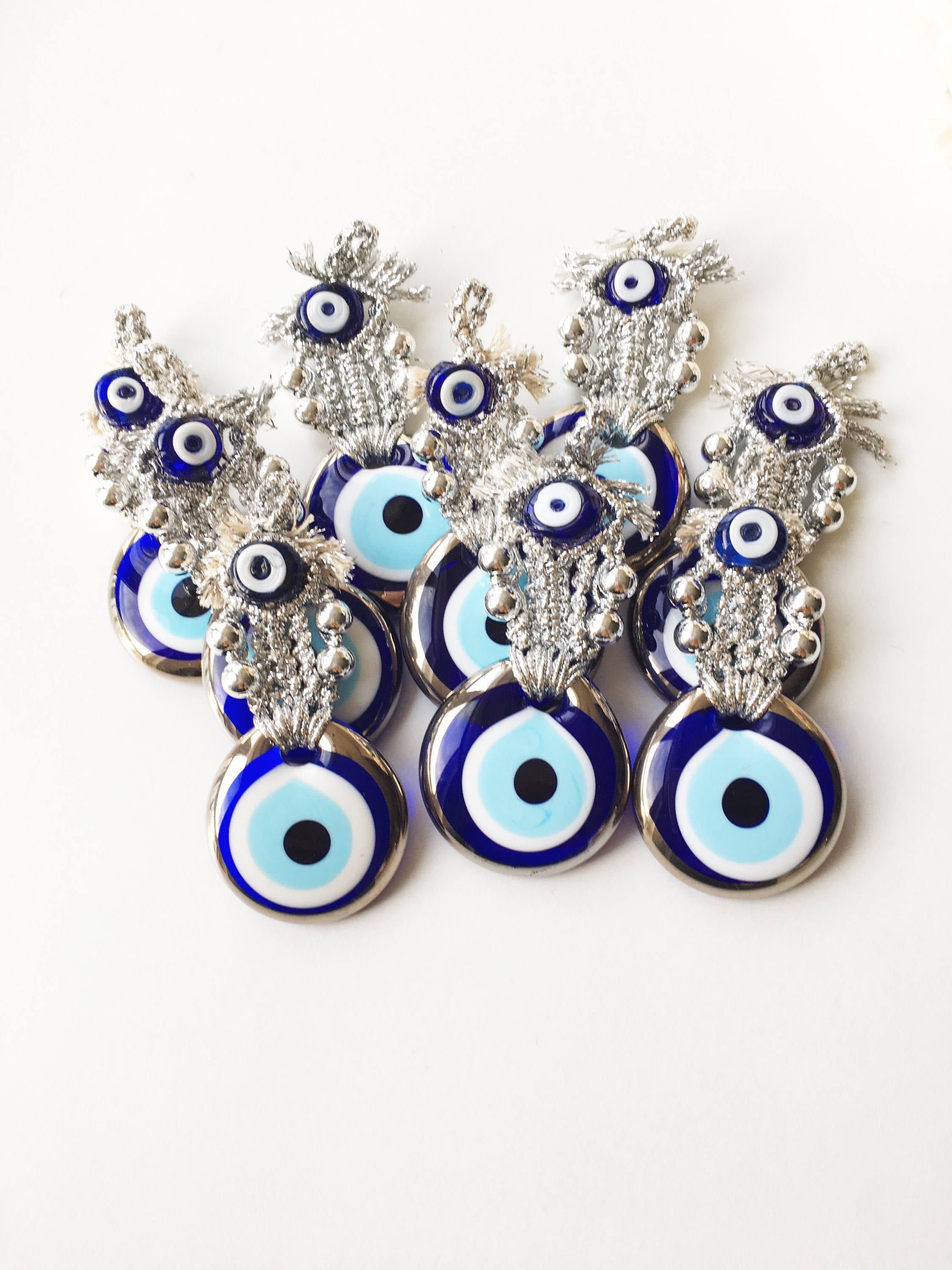 A handmade Silver Evil Eye Macrame Wall Hanging featuring a 4.5cm evil eye bead, crafted with silver macrame rope and gold accents.