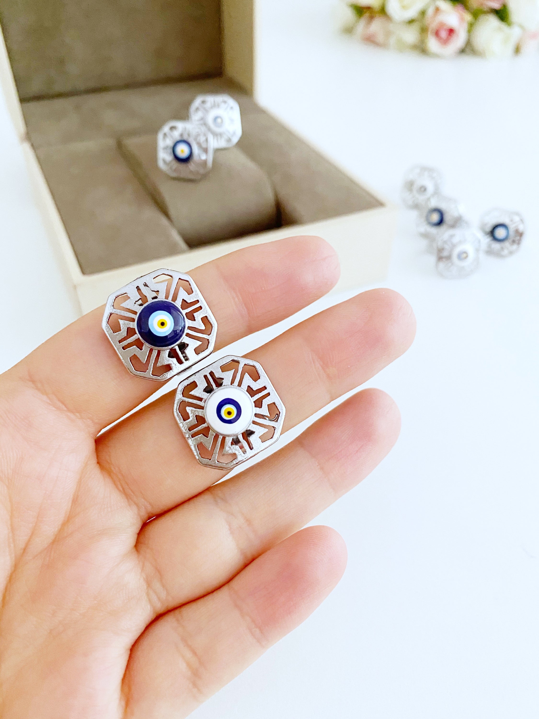 A beautiful silver adjustable evil eye ring featuring blue and white beads, symbolizing protection and style.