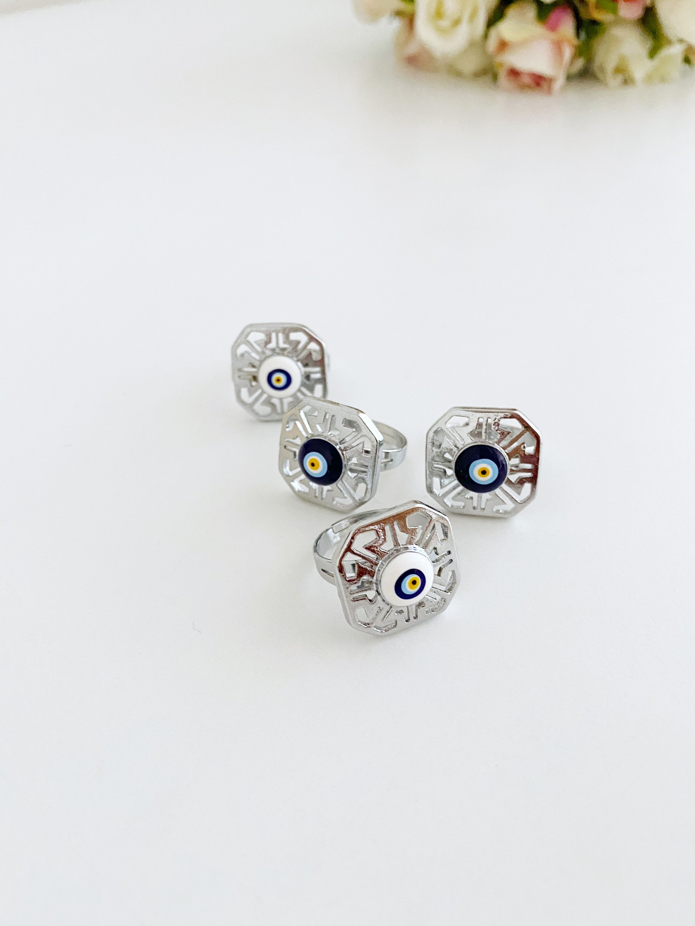 A beautiful silver adjustable evil eye ring featuring blue and white beads, symbolizing protection and style.