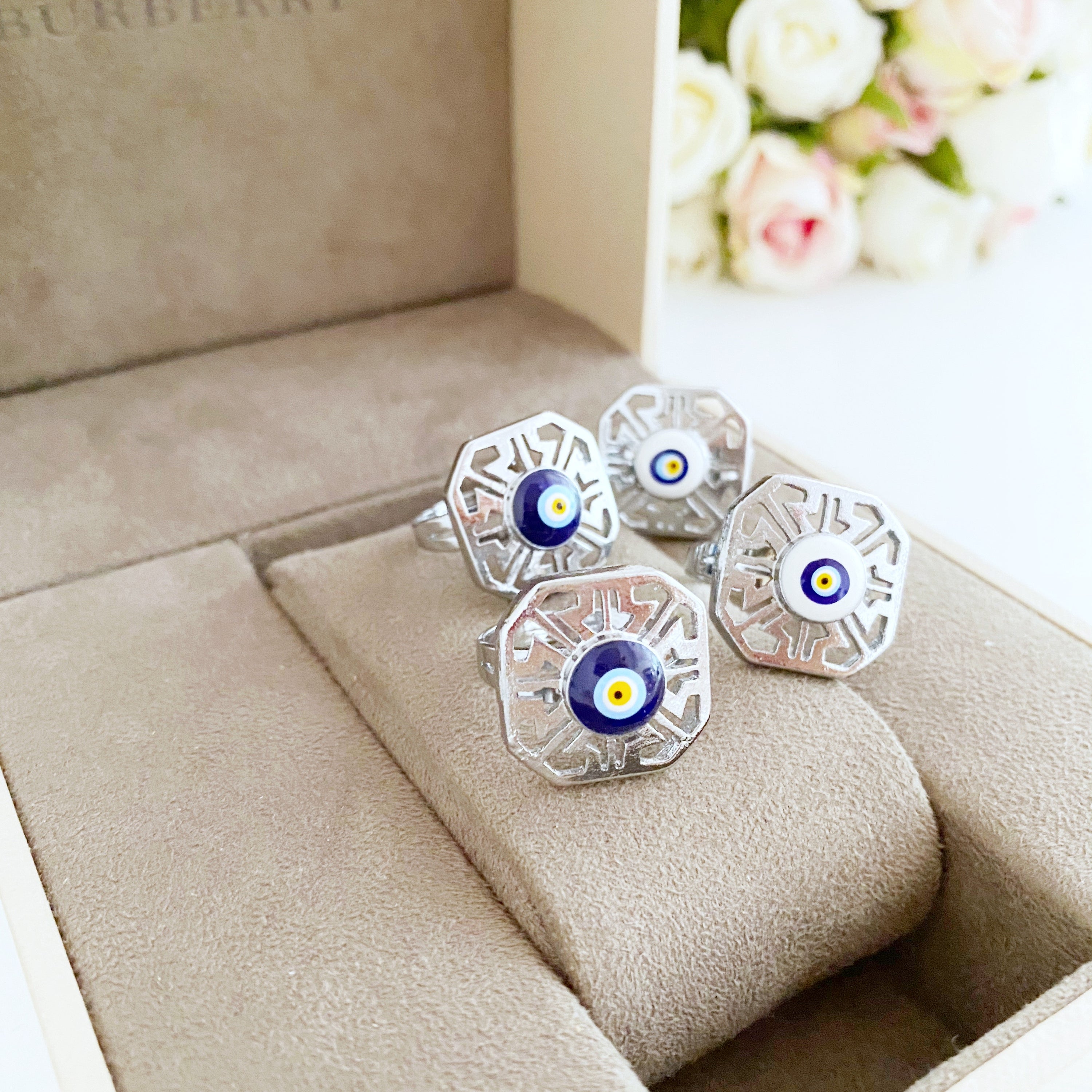 A beautiful silver adjustable evil eye ring featuring blue and white beads, symbolizing protection and style.