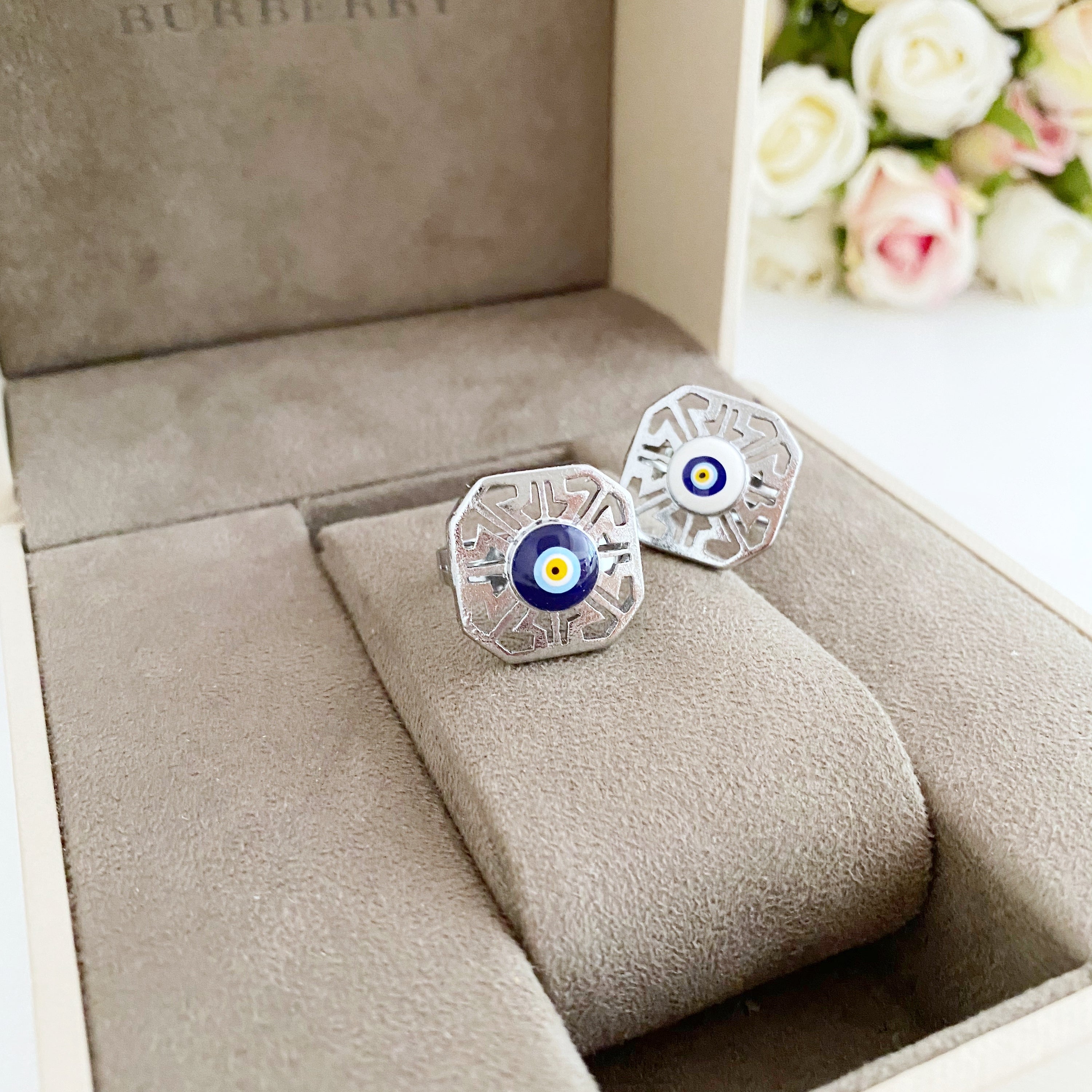 A beautiful silver adjustable evil eye ring featuring blue and white beads, symbolizing protection and style.