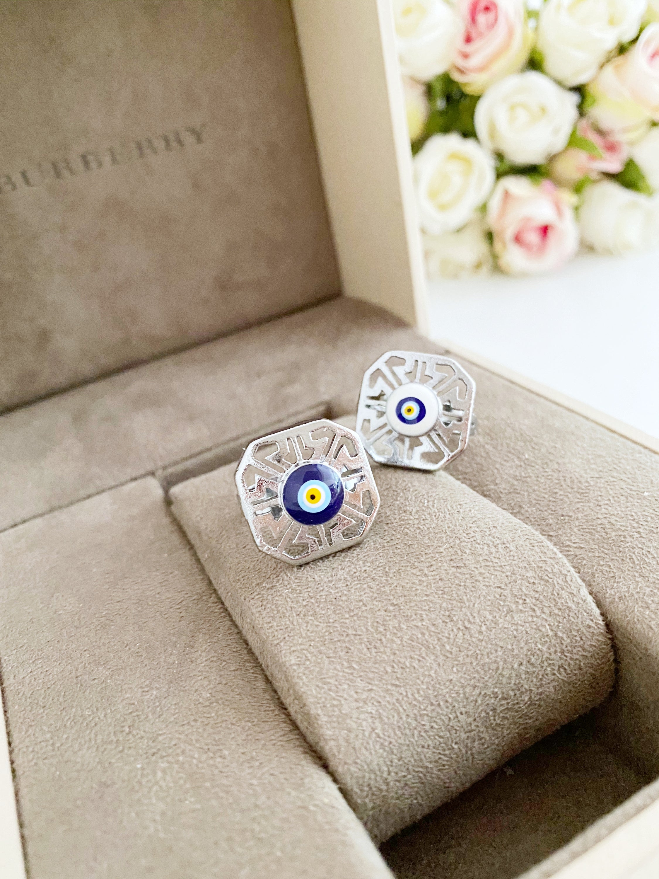 A beautiful silver adjustable evil eye ring featuring blue and white beads, symbolizing protection and style.