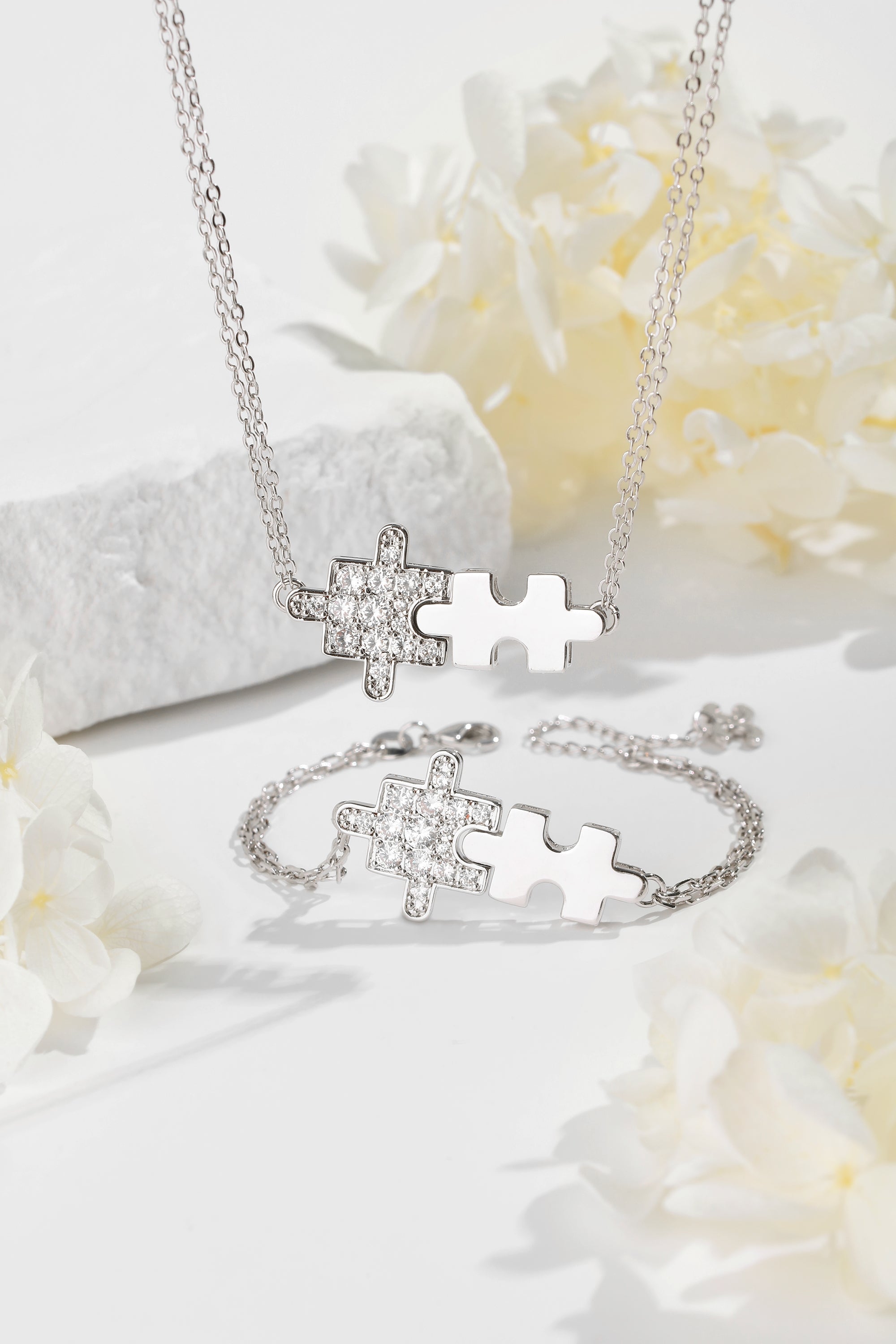 A beautiful silver bracelet featuring jigsaw puzzle-shaped charms adorned with sparkling cubic zirconia stones, showcasing its handcrafted elegance.