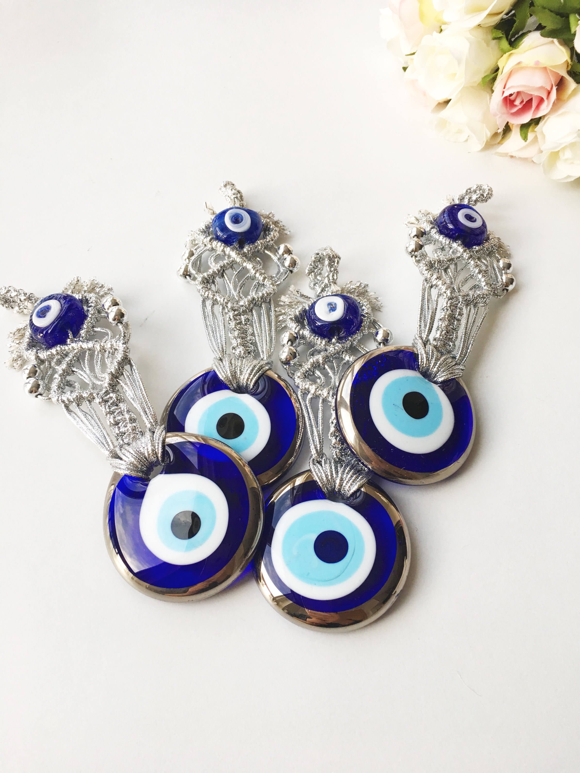 Silver Macrame Evil Eye Charm wall hanging with intricate design and blue evil eye bead.