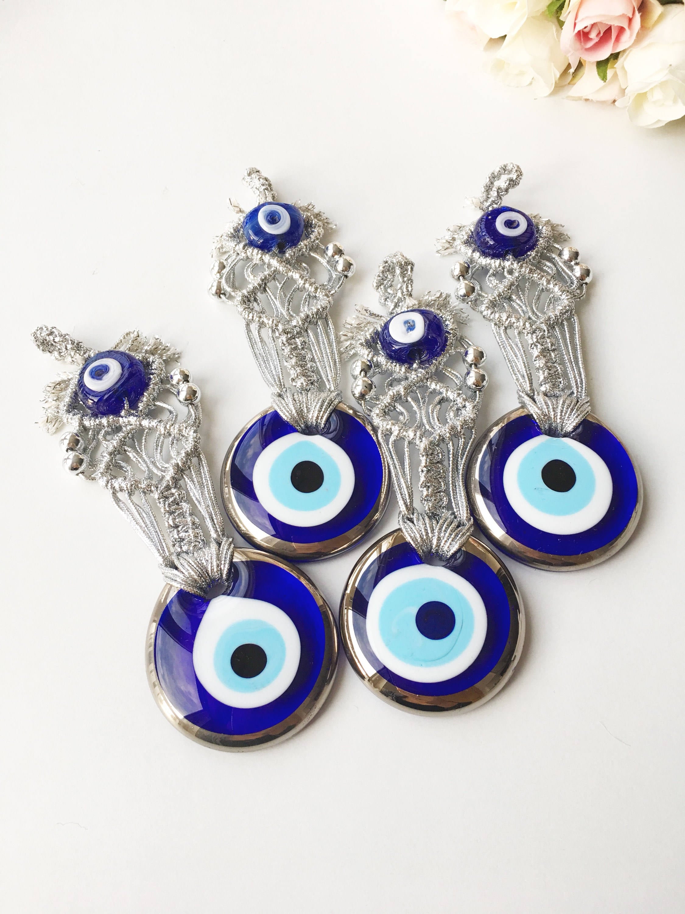 Silver Macrame Evil Eye Charm wall hanging with intricate design and blue evil eye bead.