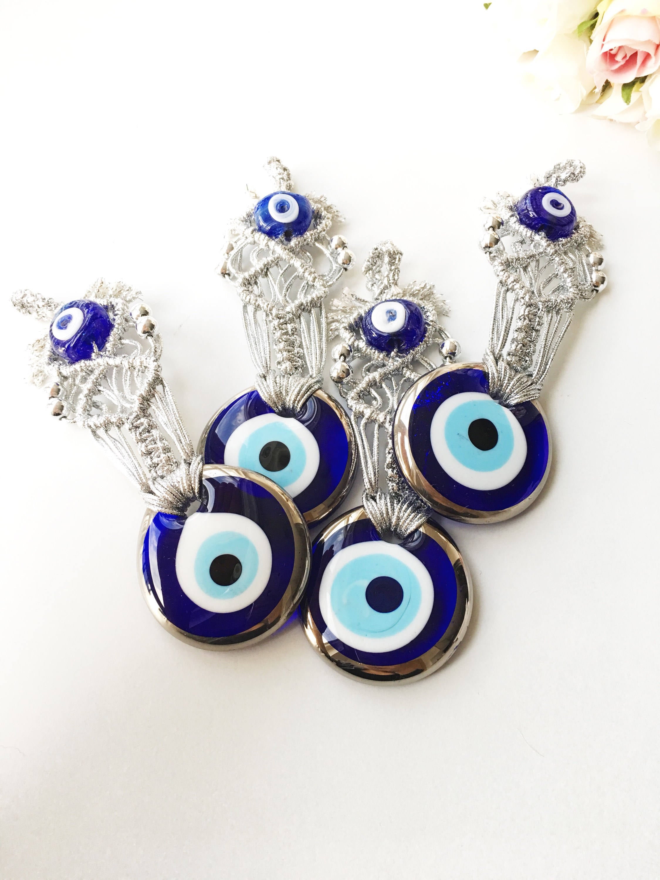 Silver Macrame Evil Eye Charm wall hanging with intricate design and blue evil eye bead.