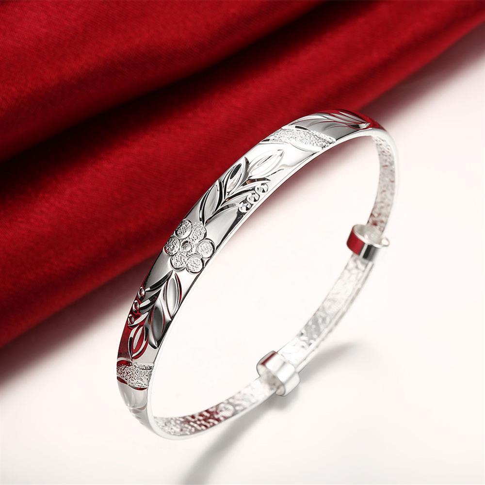 Silver plated adjustable bangle featuring a botanical gardens floral design, suitable for all wrist sizes.