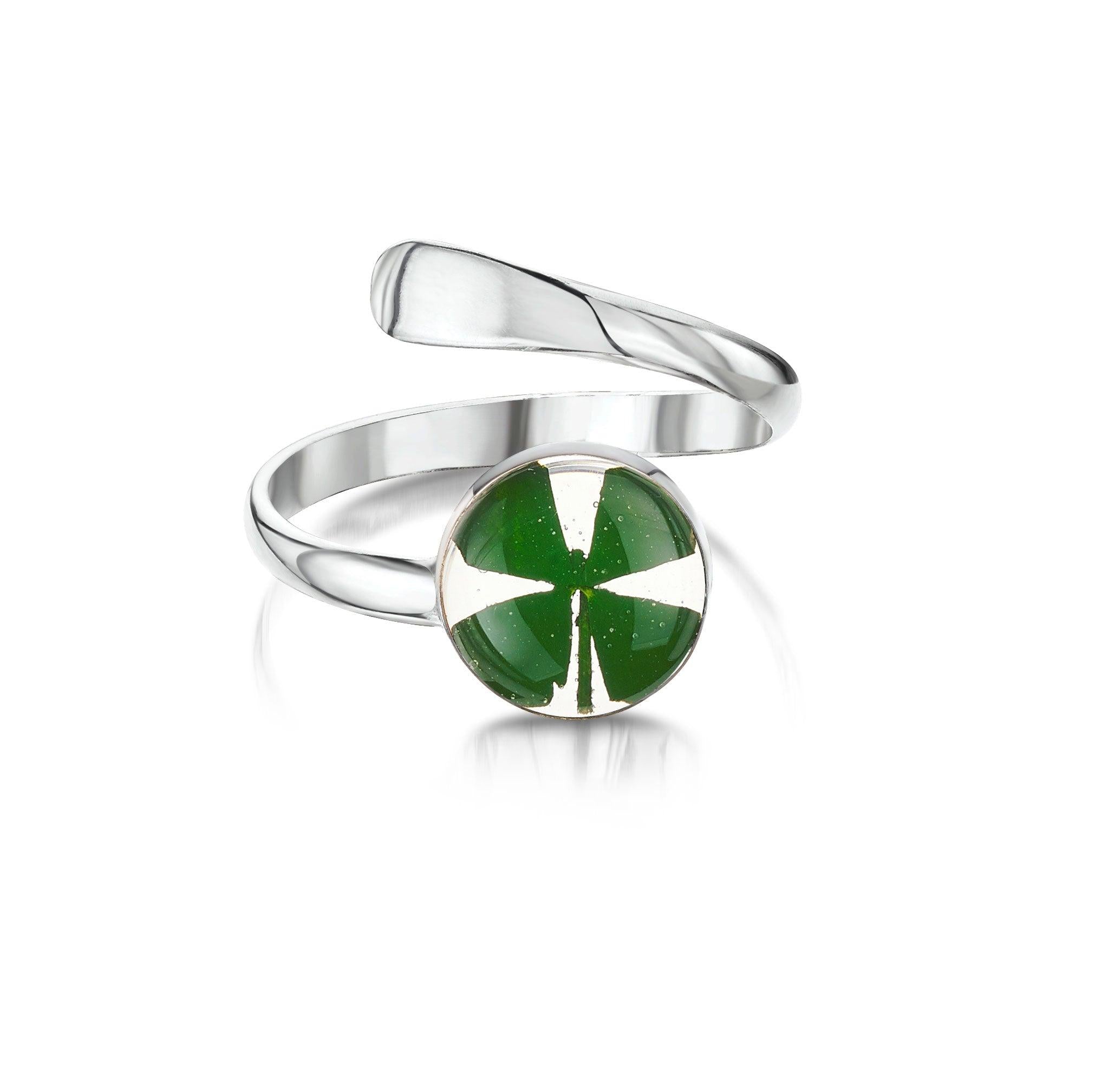 Adjustable silver ring featuring a round four leaf clover design, showcasing its elegant craftsmanship and shiny finish.