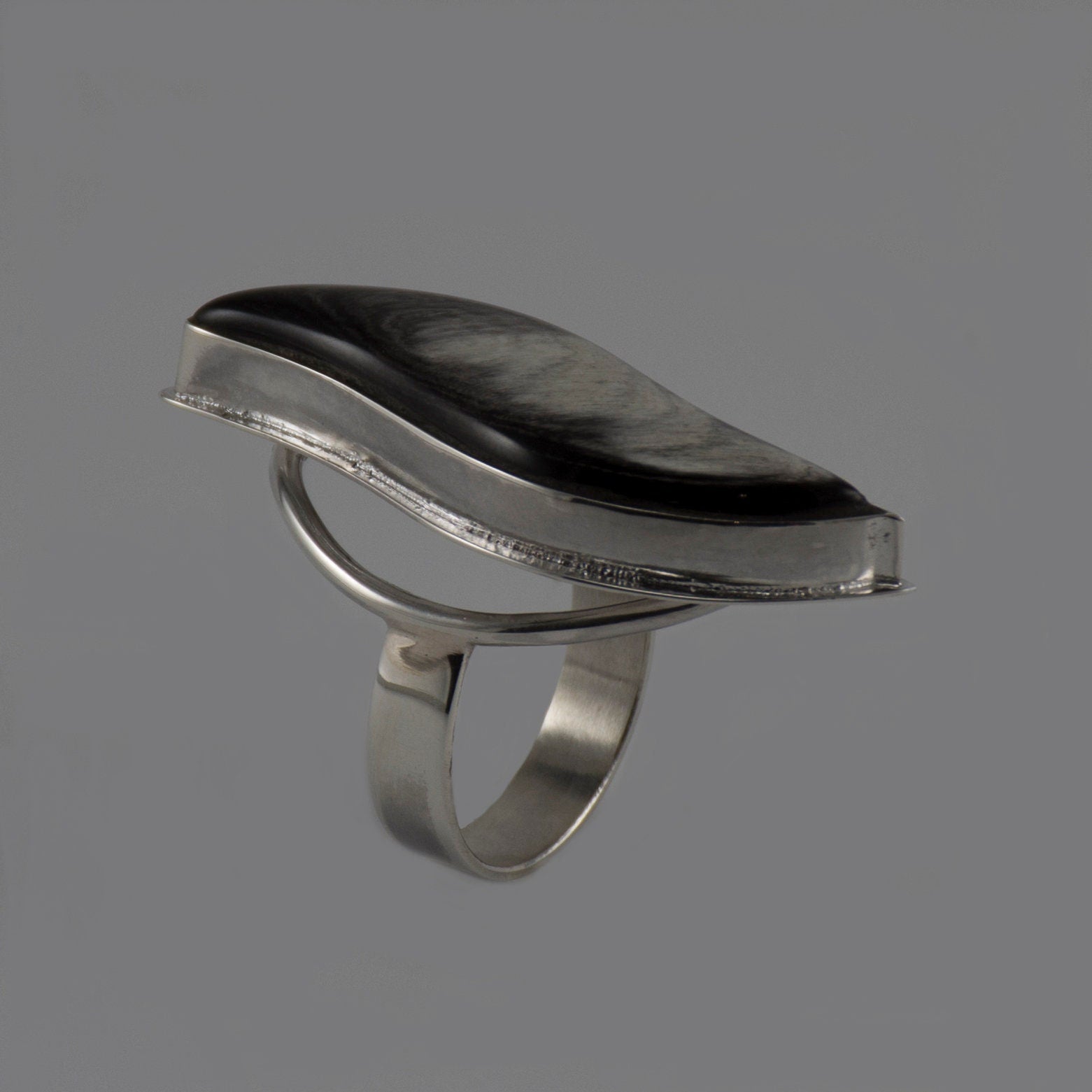 Handmade silver ring featuring a polished natural horn cabochon, showcasing a unique boho design.