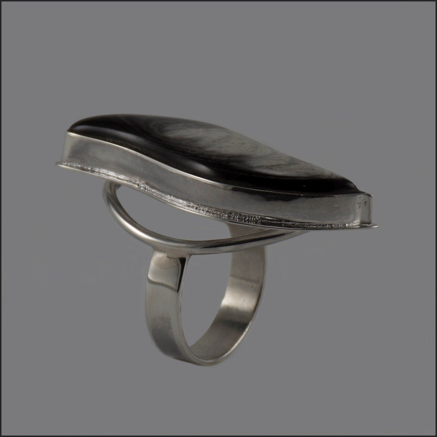 Handmade silver ring featuring a polished natural horn cabochon, showcasing a unique boho design.